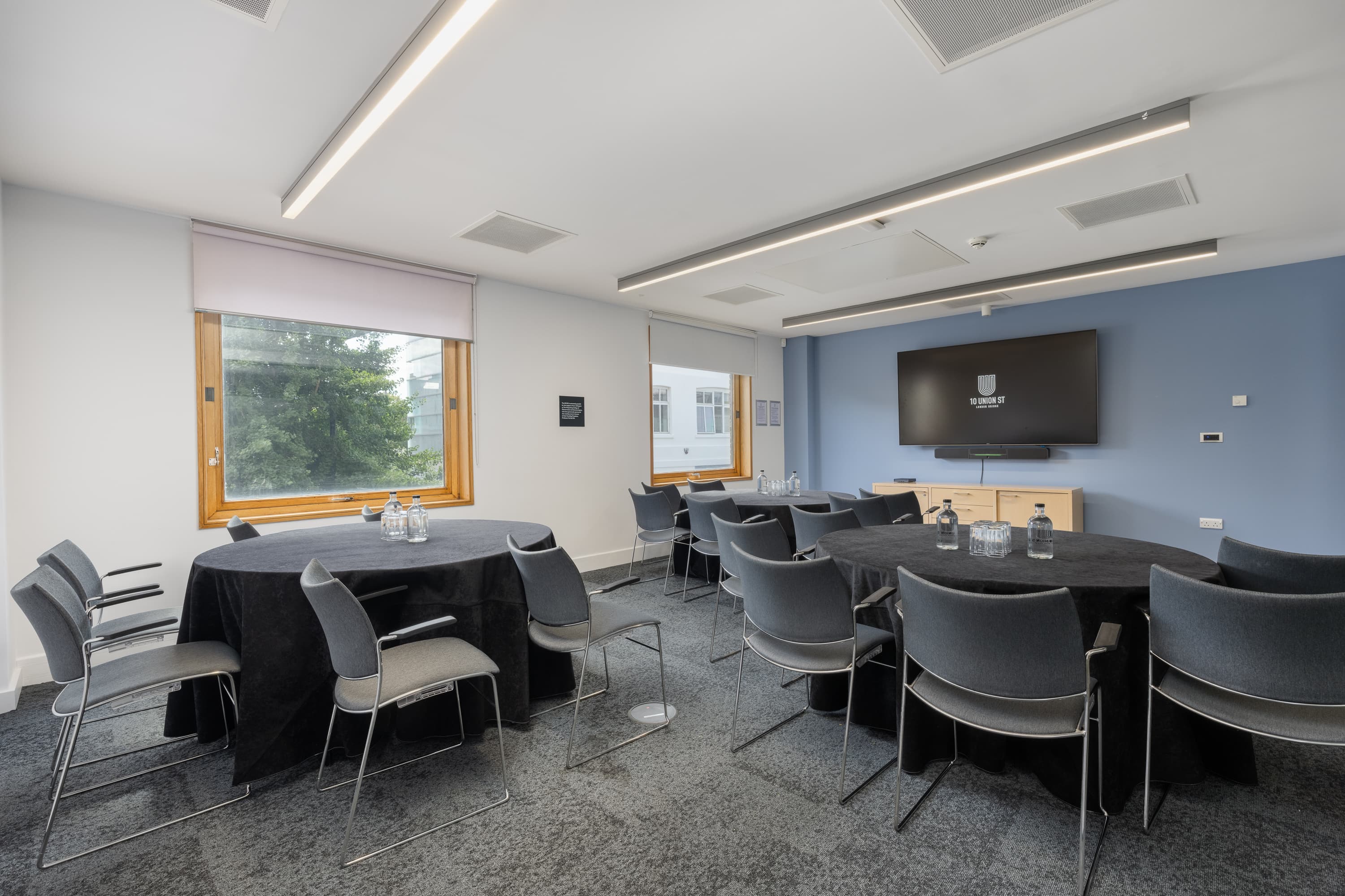 Modern breakout room with round tables for collaborative workshop and meeting events.