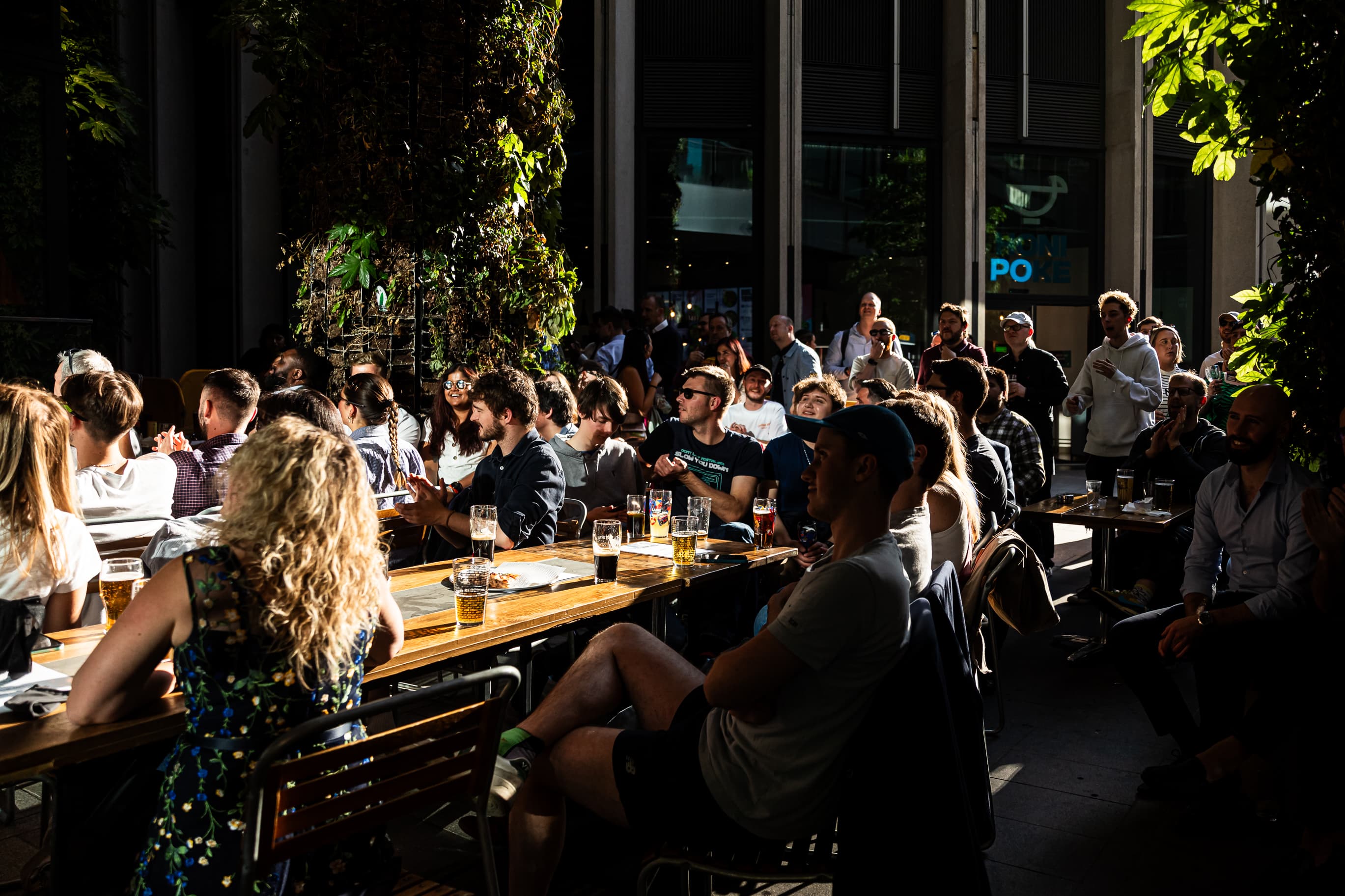 Networking mixer at Big Belly Bar terrace with long-table seating for corporate events.