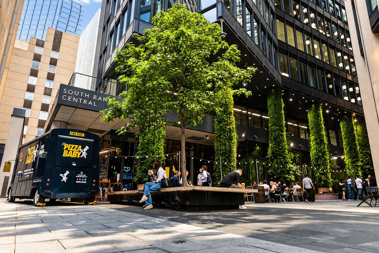 Urban outdoor terrace with string lights for corporate networking and happy hour events.