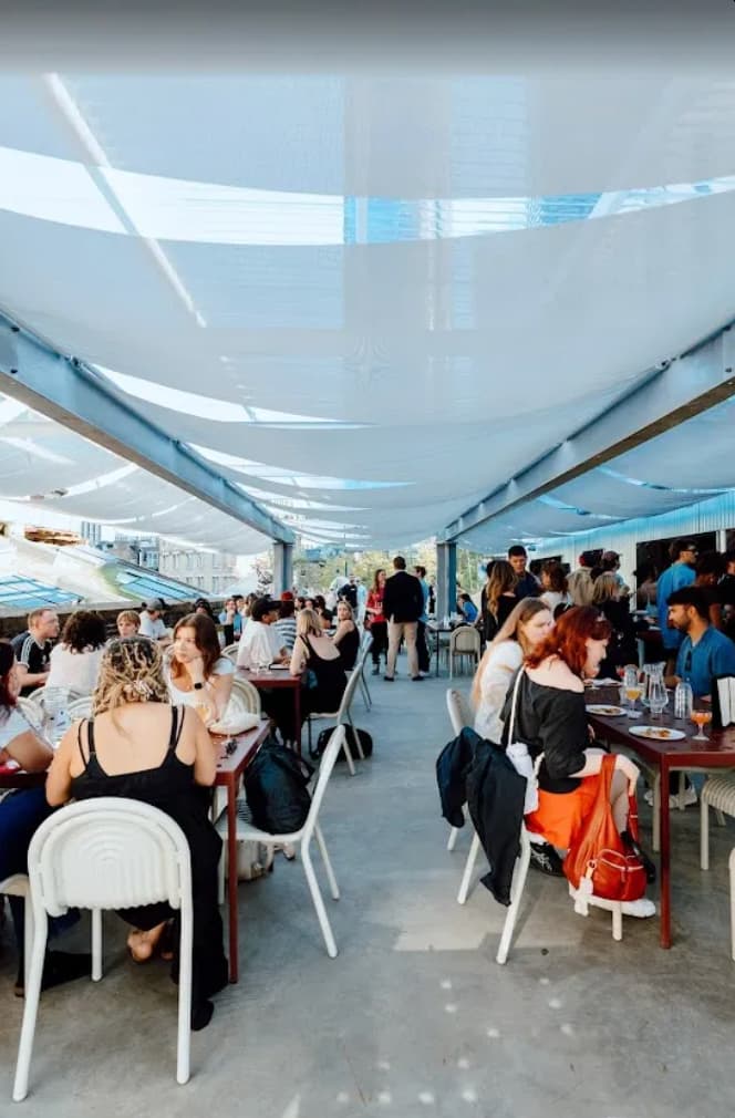 Village Underground rooftop event space with shade structures for social networking and reception.