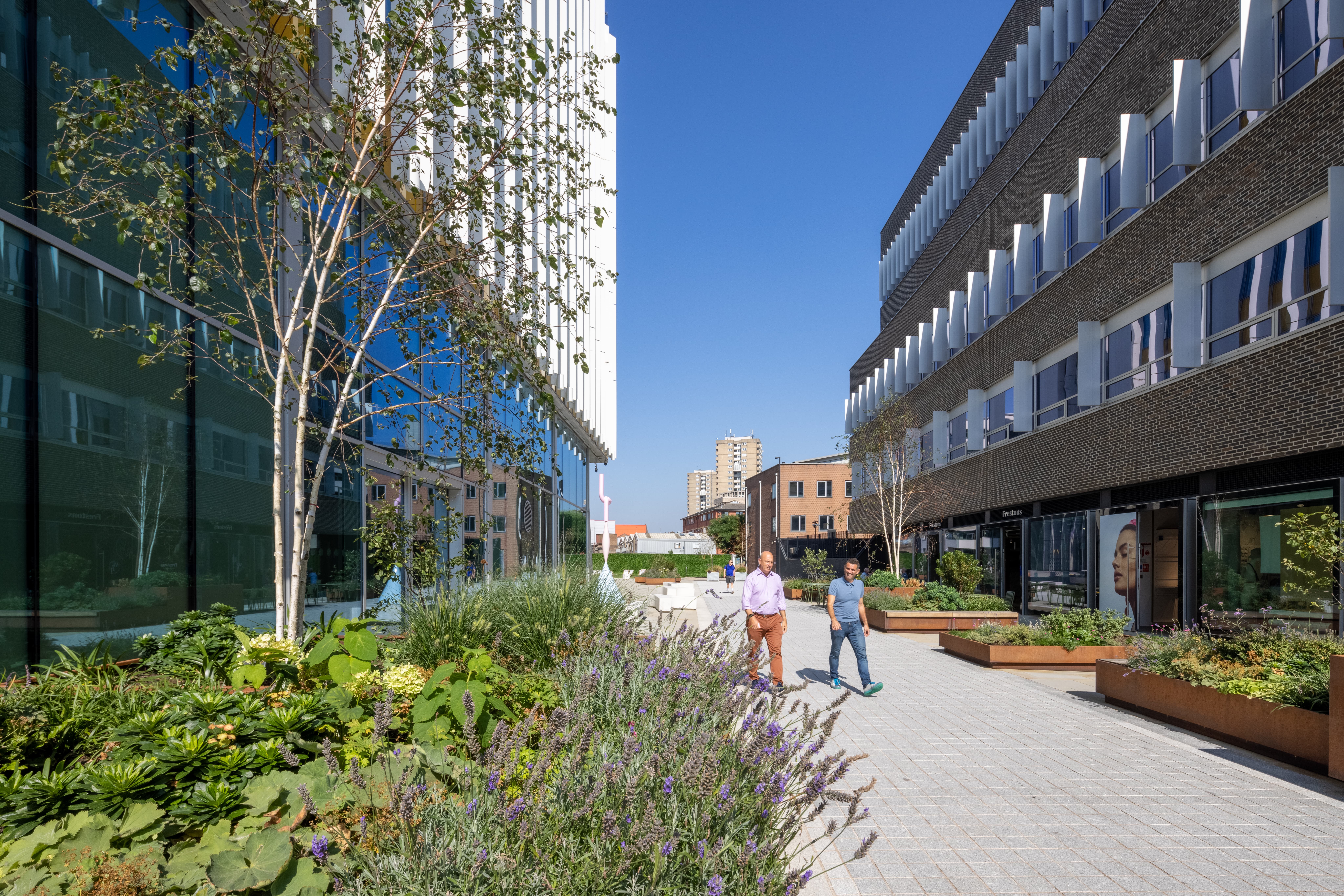Modern outdoor breakout space with greenery for networking events and alfresco registration.