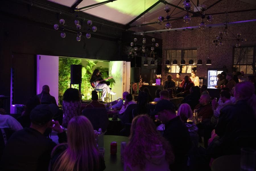 West Lounge event space featuring industrial decor for panel discussions and live performances.