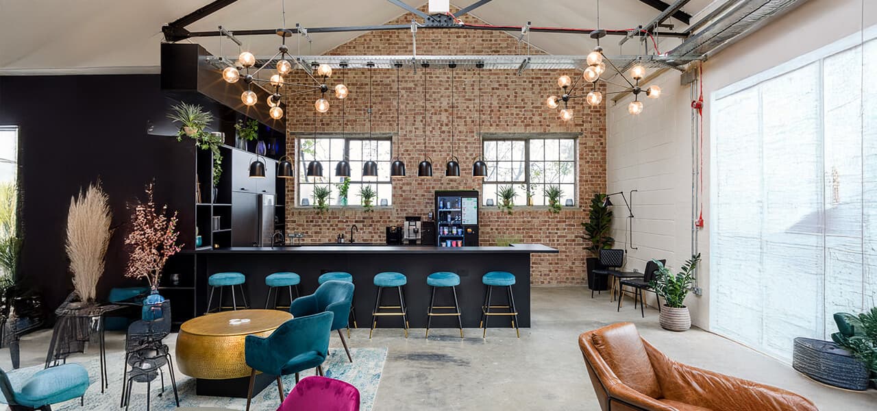 Industrial-chic West Lounge at Qube Acton for networking events and corporate workshops.