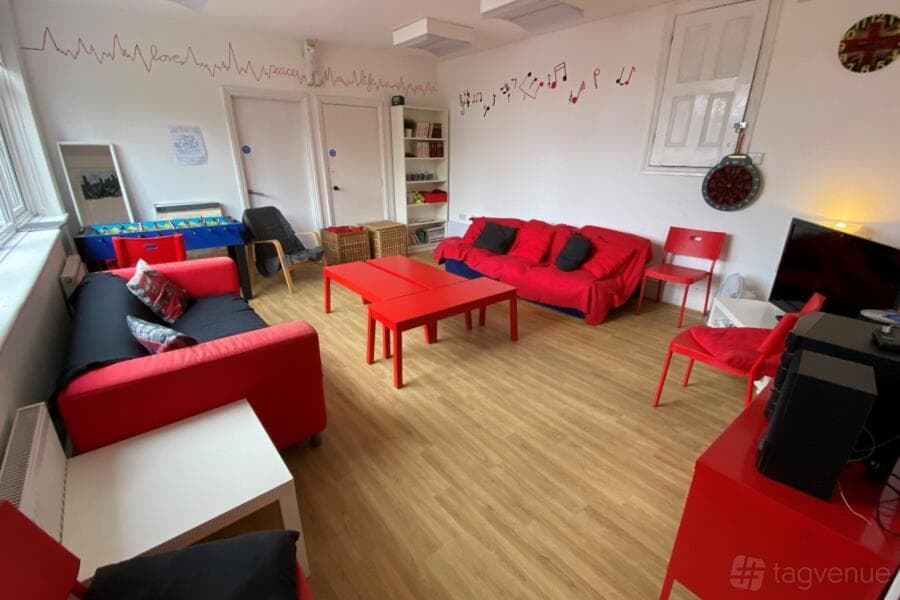 Qube Acton Studio A breakout room with vibrant furniture for creative team building events.