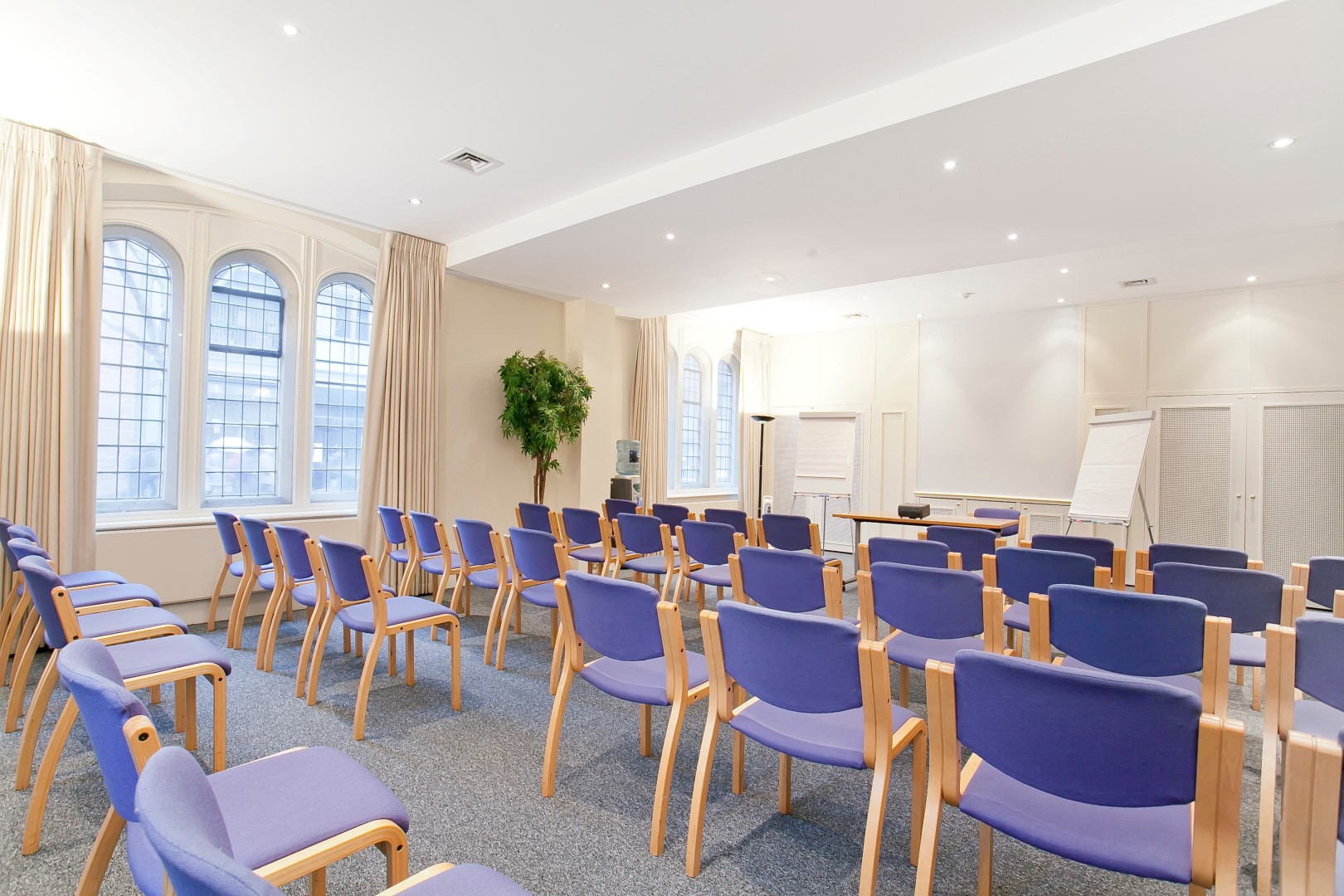 Trevelyan Hall meeting room with purple chairs, ideal for workshops and presentations.