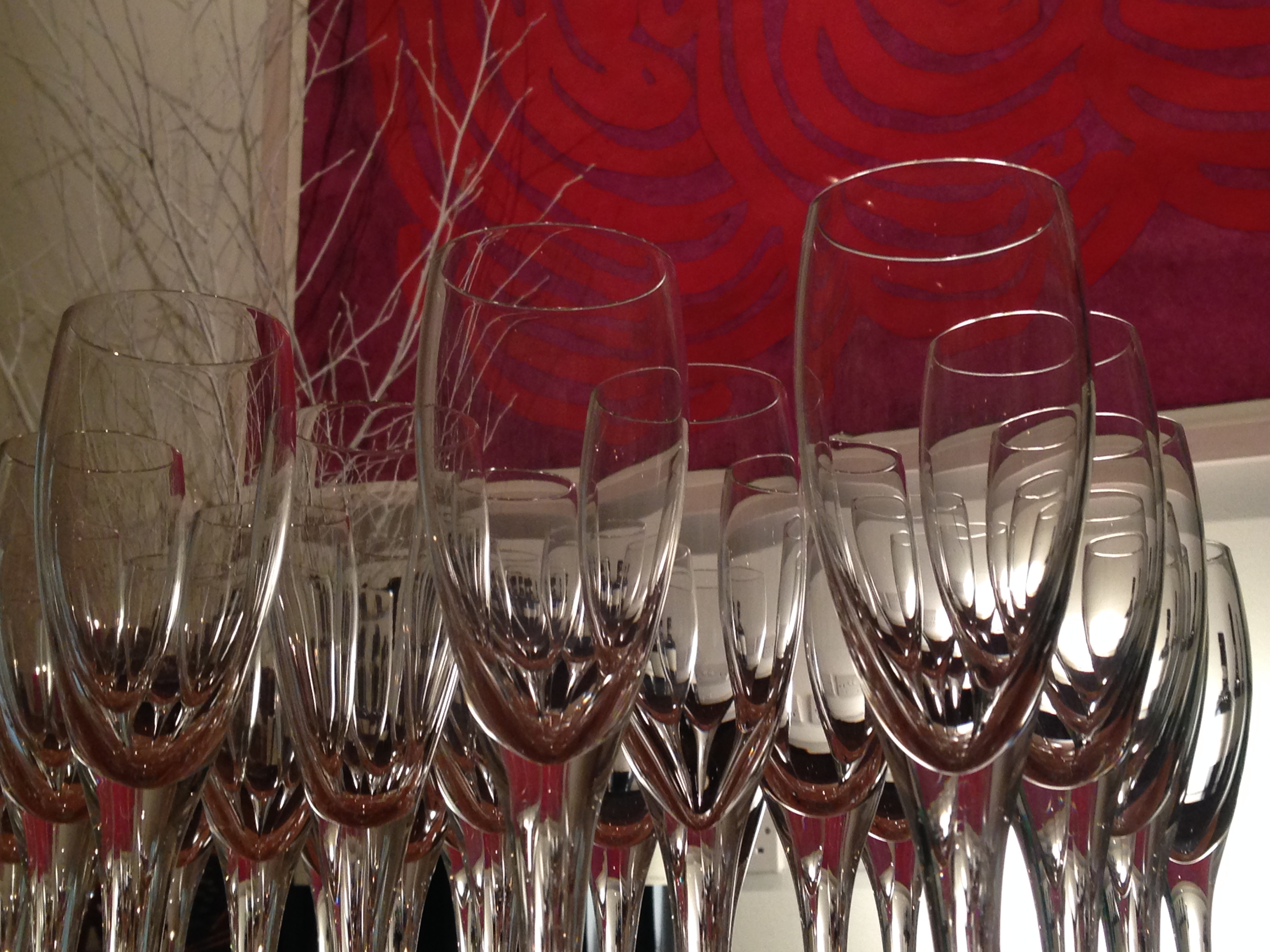 Elegant champagne flutes in a vibrant event setting at October Gallery.