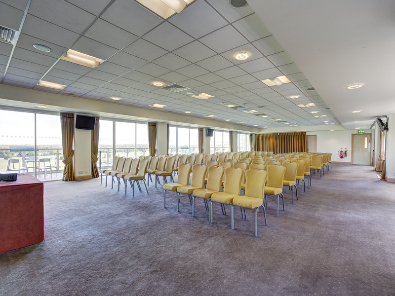 Park View Suite at Sandown Park: spacious meeting room with yellow chairs for events.