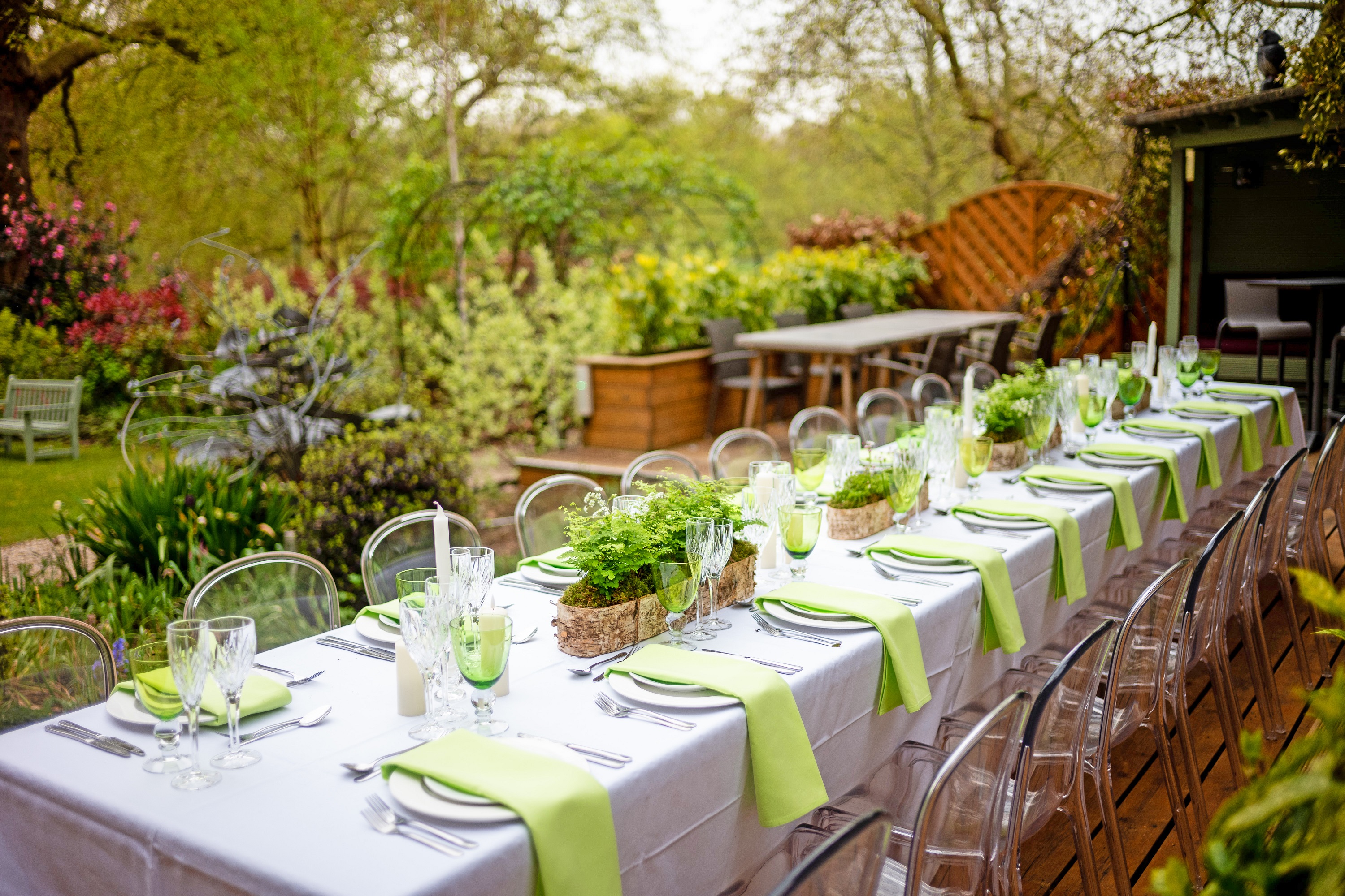Elegant outdoor dining table in garden, perfect for weddings and corporate retreats.