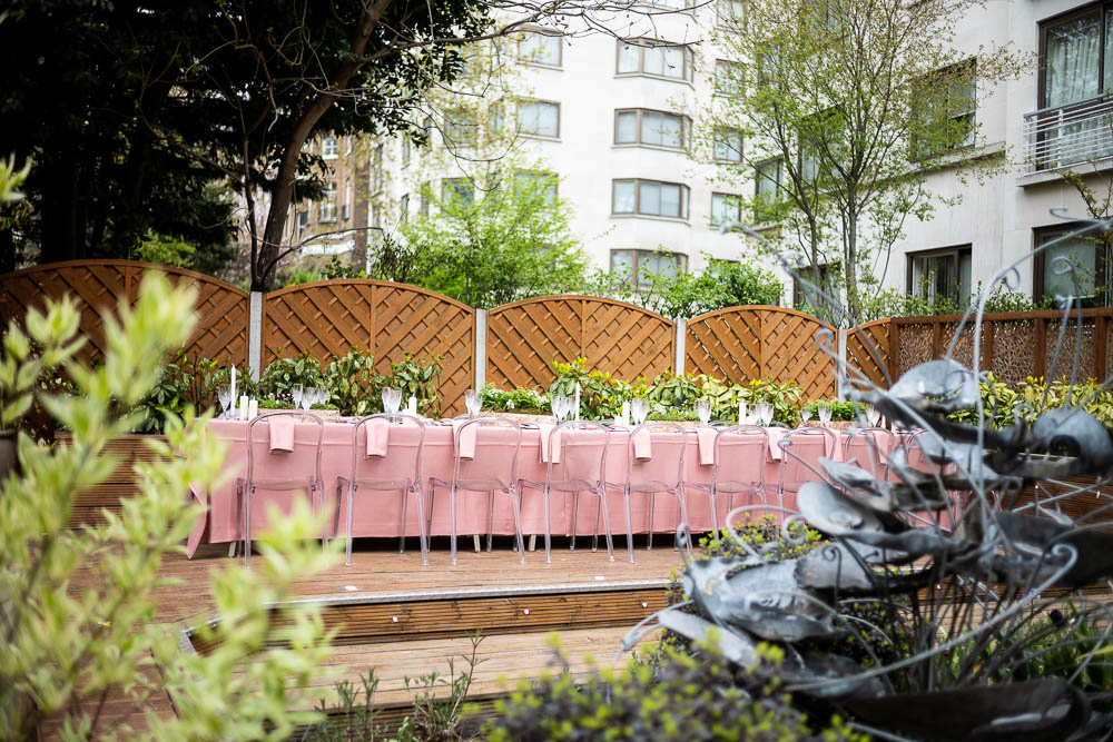 Elegant outdoor dining area with pink linens, perfect for intimate gatherings or corporate events.