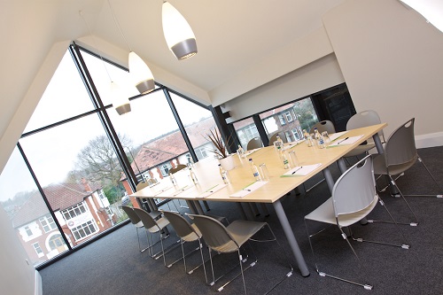 Modern Wilberforce Room with large windows, ideal for corporate meetings and workshops.