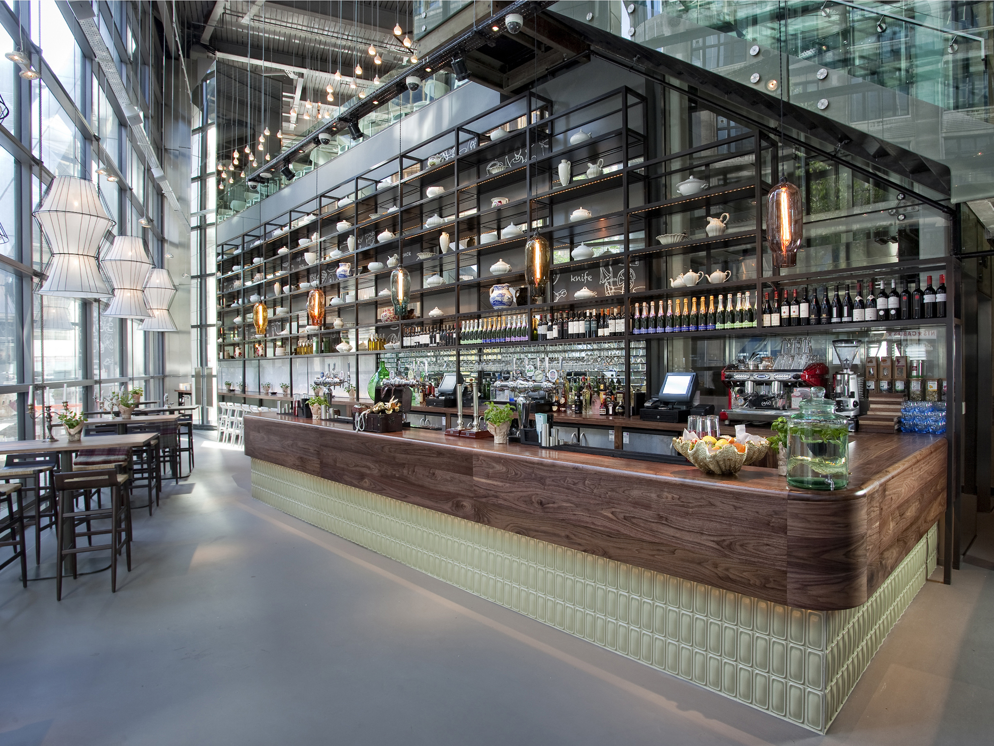 Modern bar area with sleek shelving, ideal for networking events and casual meetings.