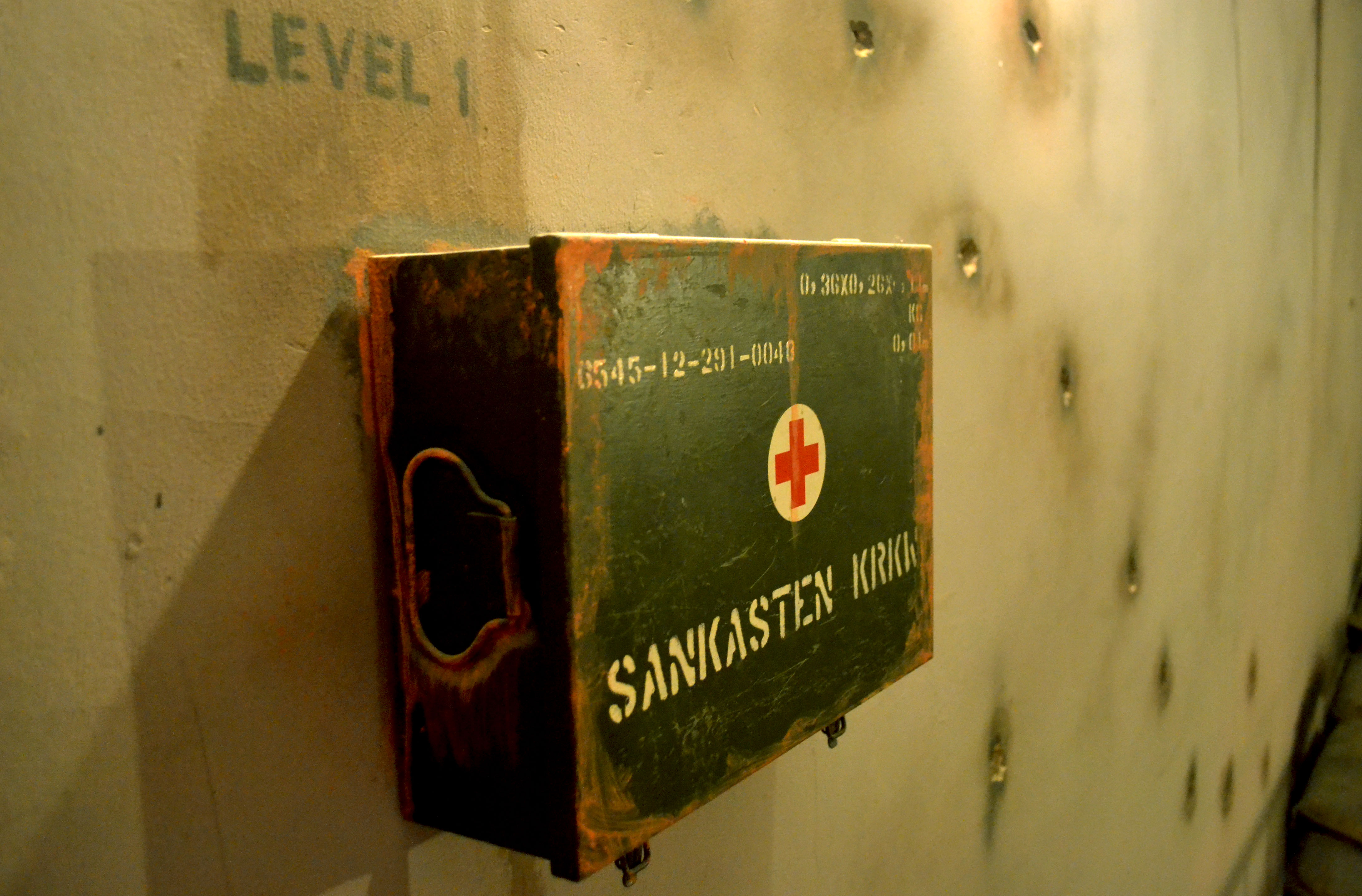 Vintage first aid kit on wall at Bunker 51 venue for event safety and preparedness.