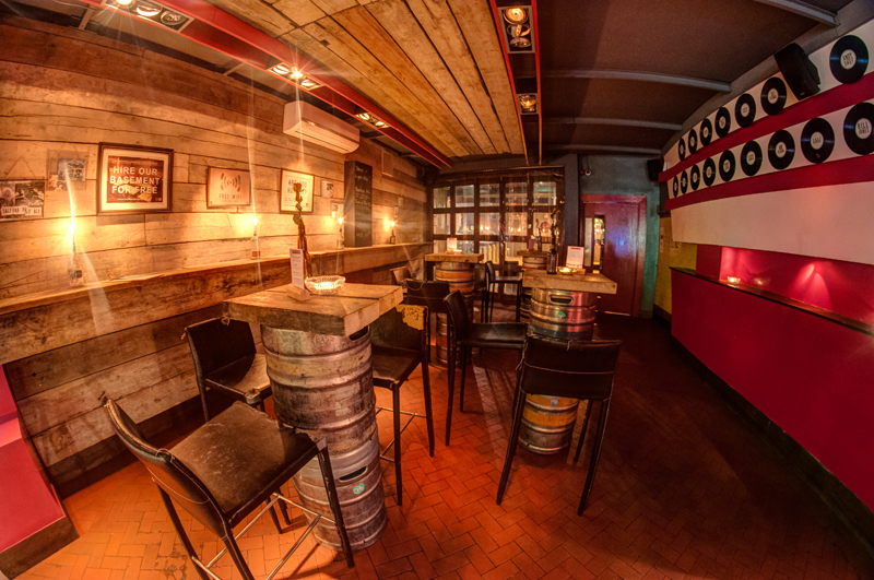 Cozy rustic venue with barrel tables for intimate gatherings and networking events.