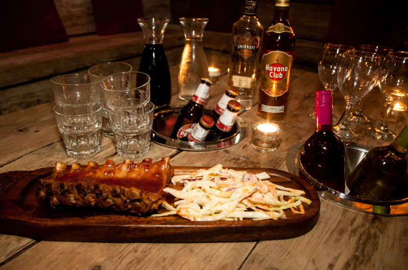 Casual networking event setup with ribs, coleslaw, and elegant glassware in Cord.