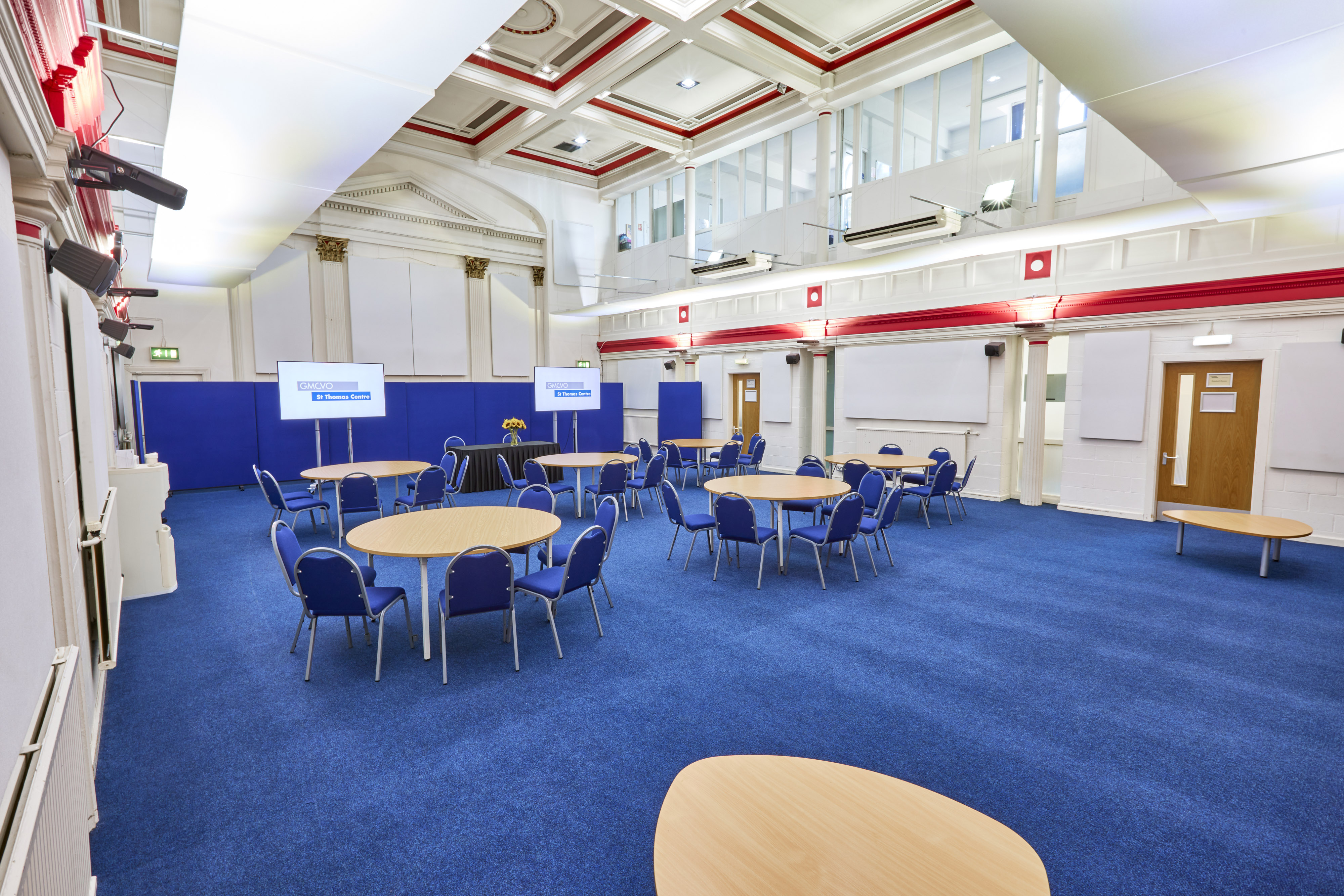 Main Hall in St Thomas Centre with round tables, ideal for meetings and conferences.