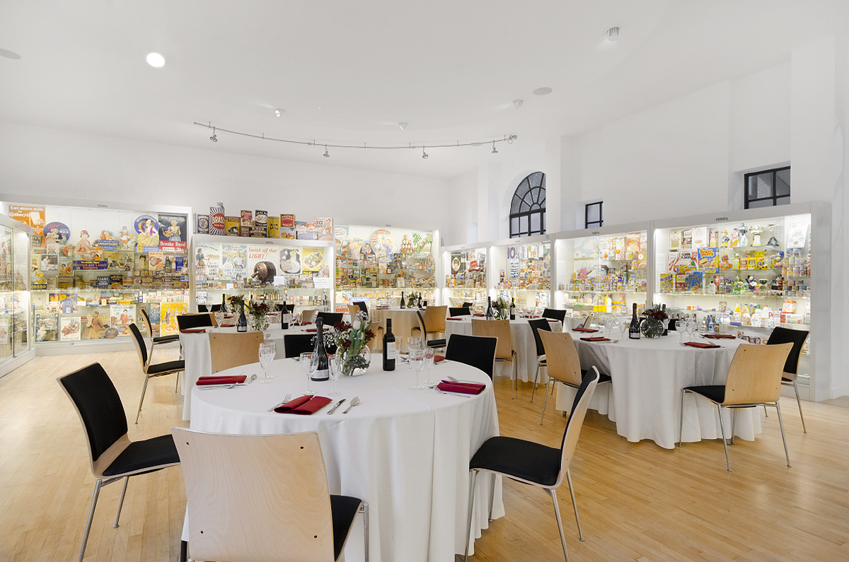 Elegant event space at Museum of Brands with round tables for corporate meetings.