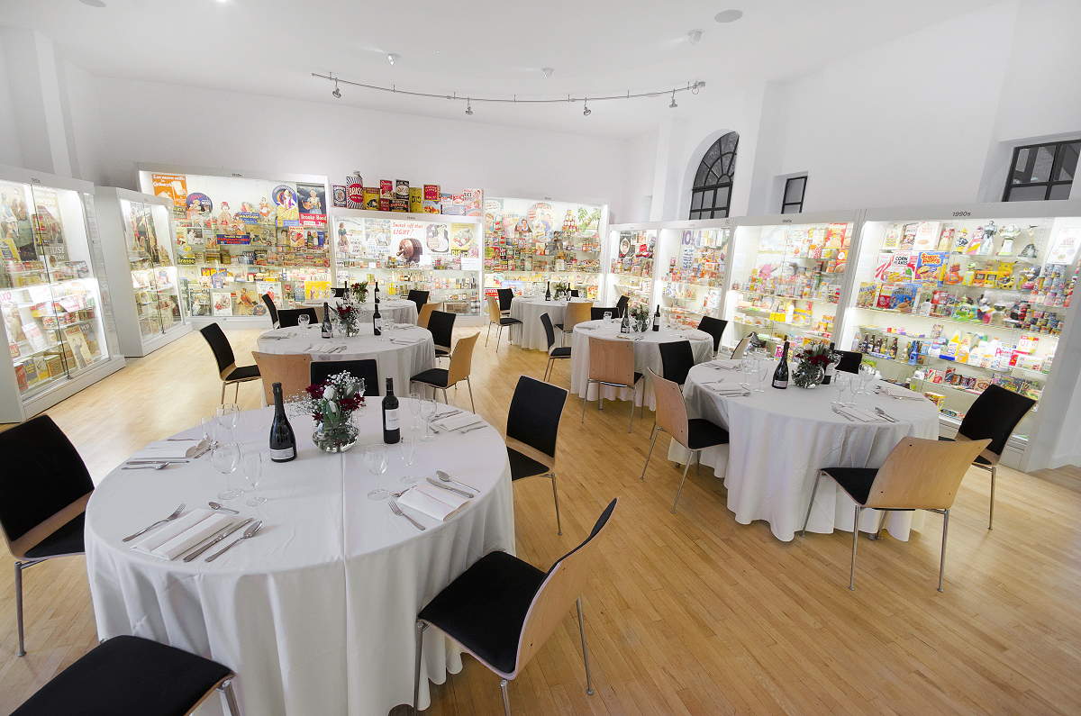 Elegant event space at Museum of Brands with round tables for corporate dinners.