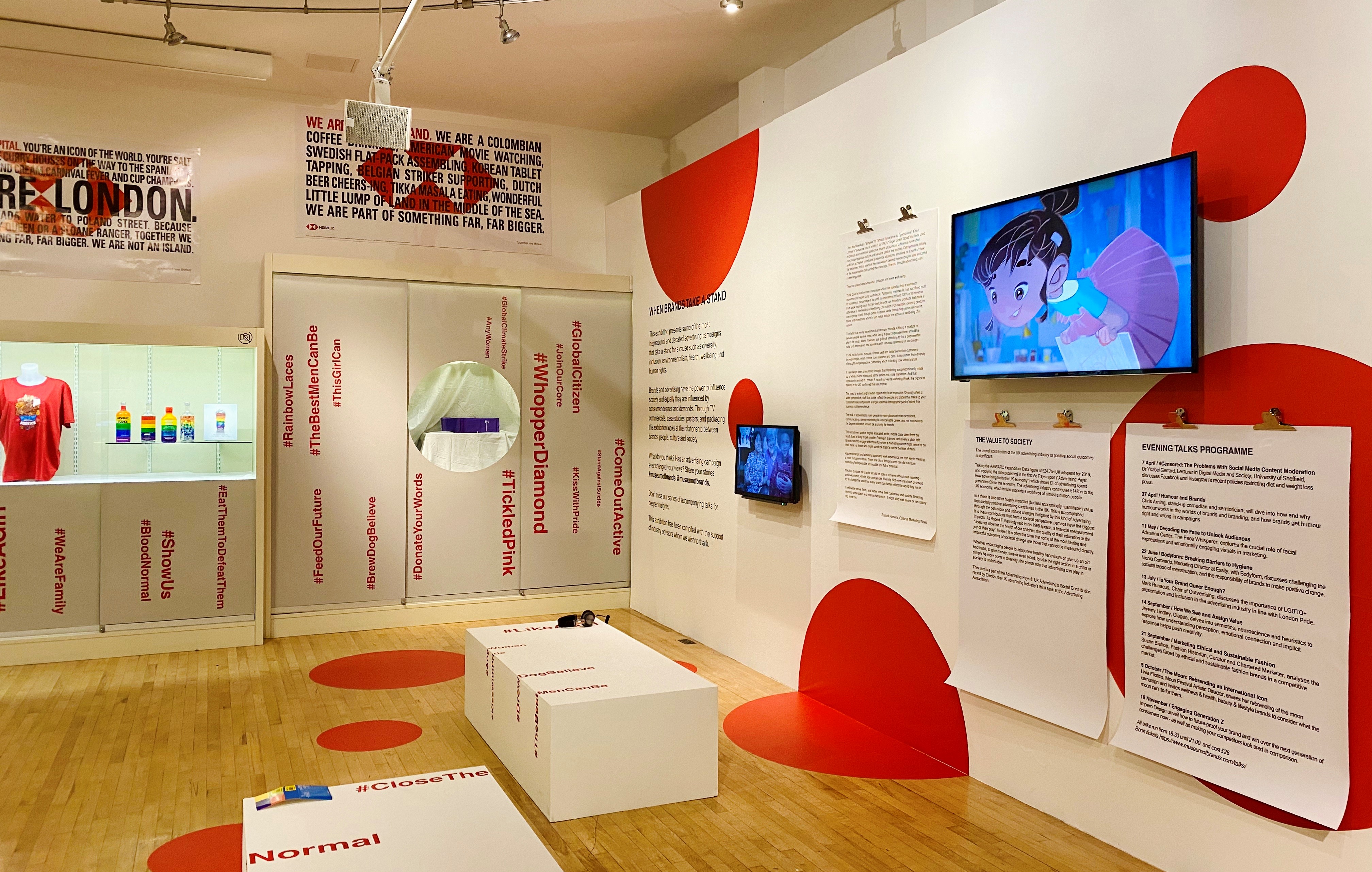 Modern event space at Museum of Brands with vibrant red accents for workshops and exhibitions.