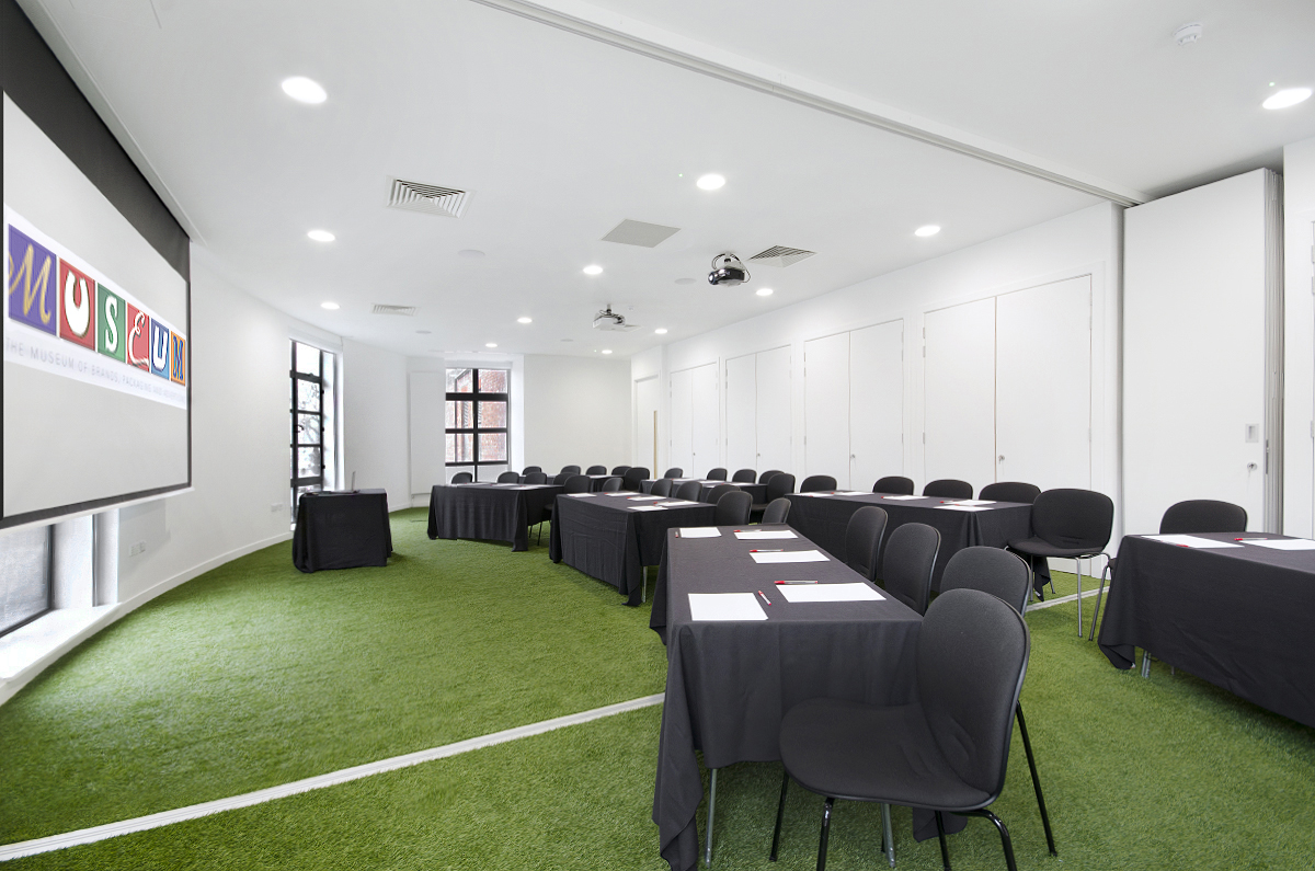 Modern conference room with turf flooring for creative workshops and meetings.