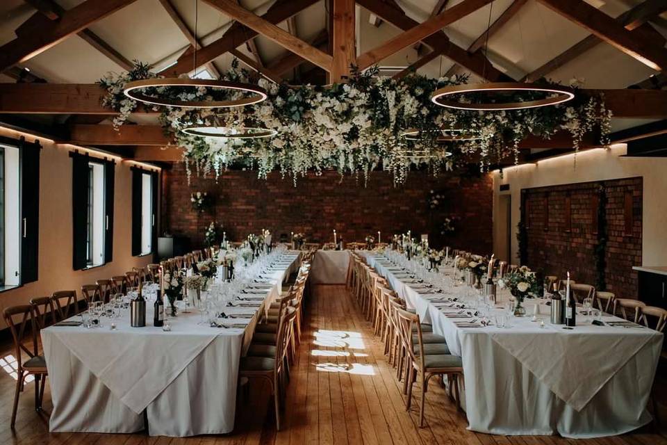 Rustic-chic banquet setup in The Merchant Room with floral installation for formal wedding events.