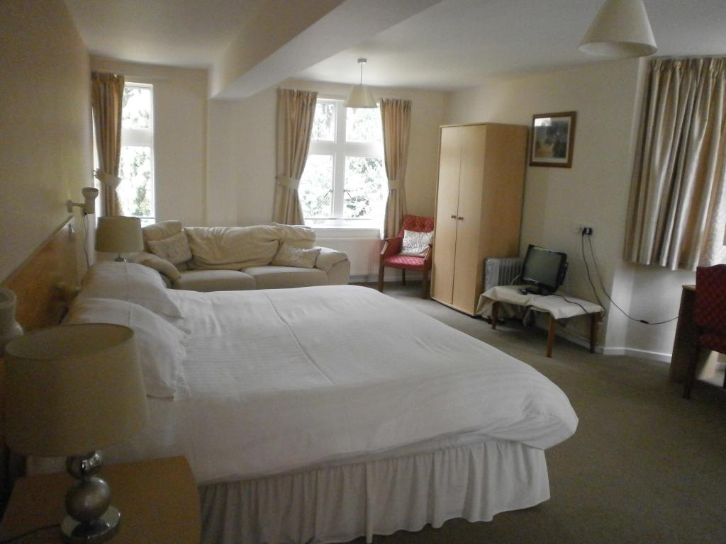 Spacious Richardson Room at Hedley Lodge, featuring a cozy bed and bright meeting space.