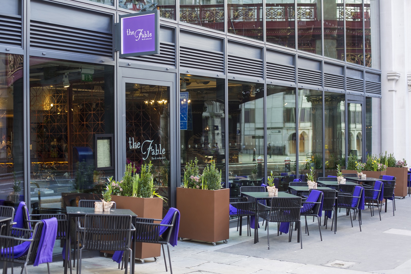 Modern venue with outdoor seating, ideal for casual meetings and networking events.