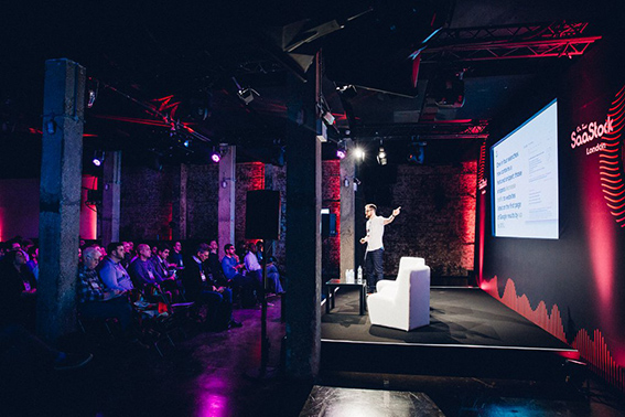 Dynamic event space with speaker, industrial design, ideal for presentations and networking.