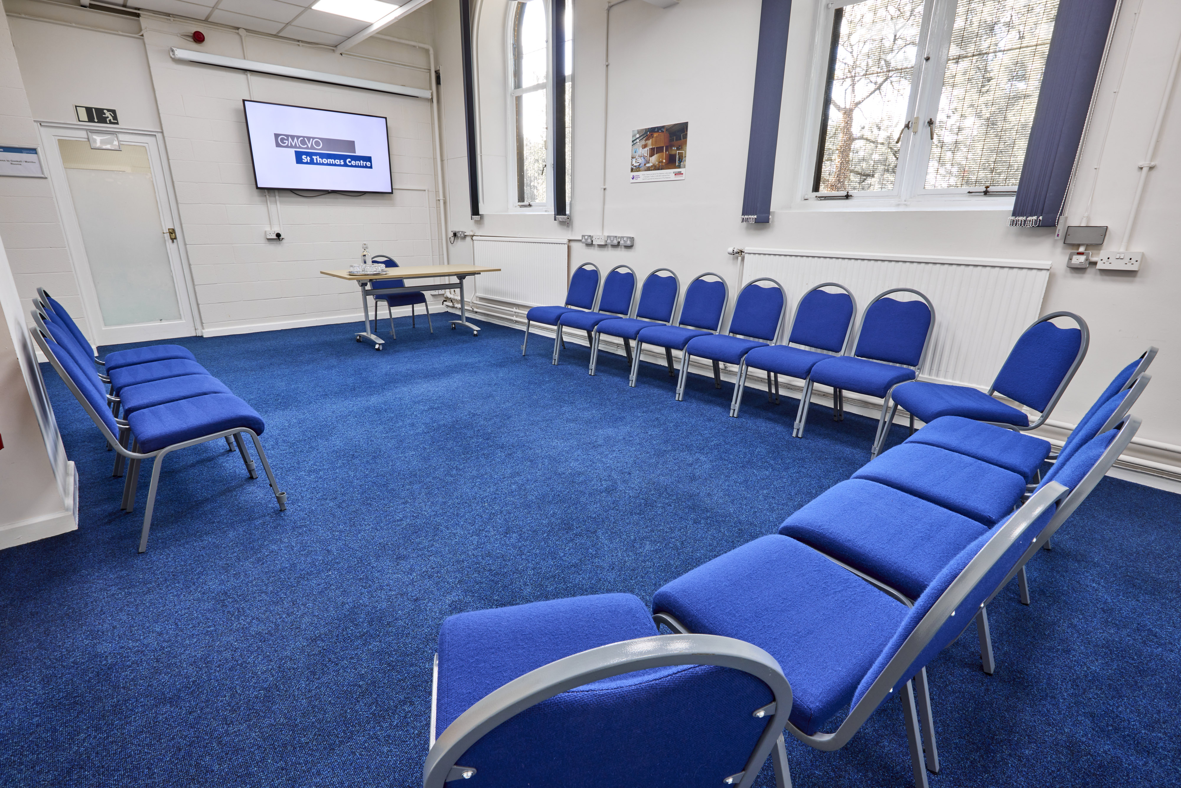 Wilkinson Room at St Thomas Centre: circular blue chairs for workshops and meetings.