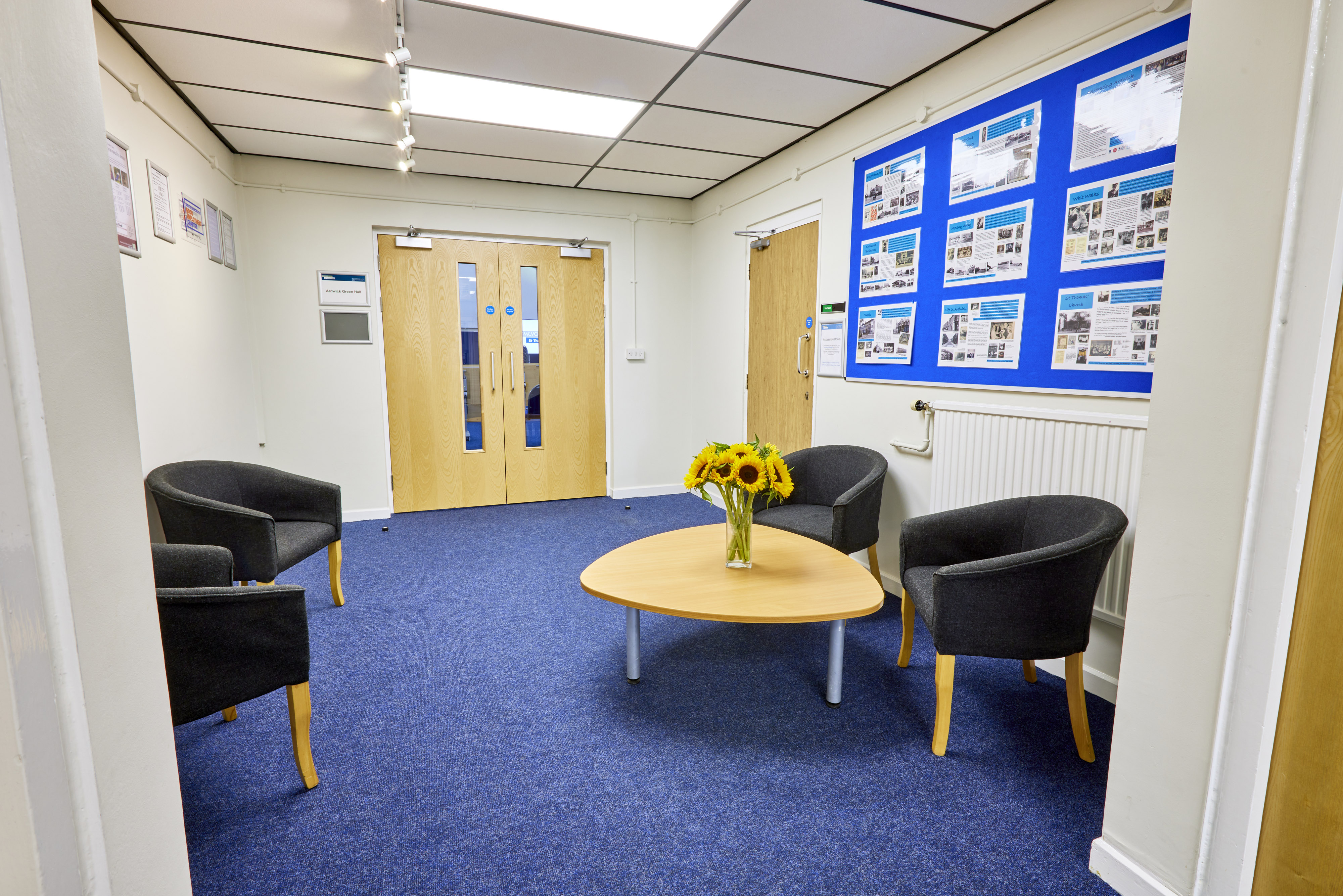 Welcoming reception area at St Thomas Centre with bright sunflowers for events and meetings.