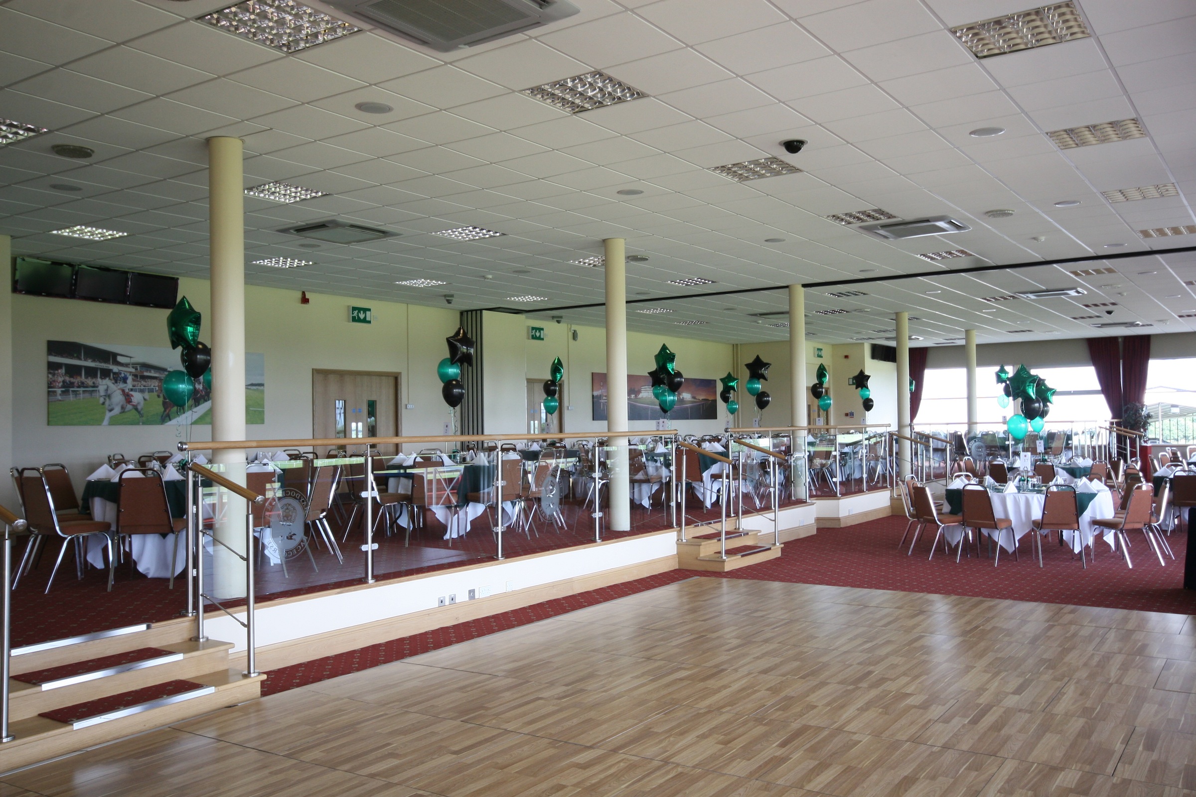 Spacious Park Suite venue with round tables, ideal for corporate events and celebrations.