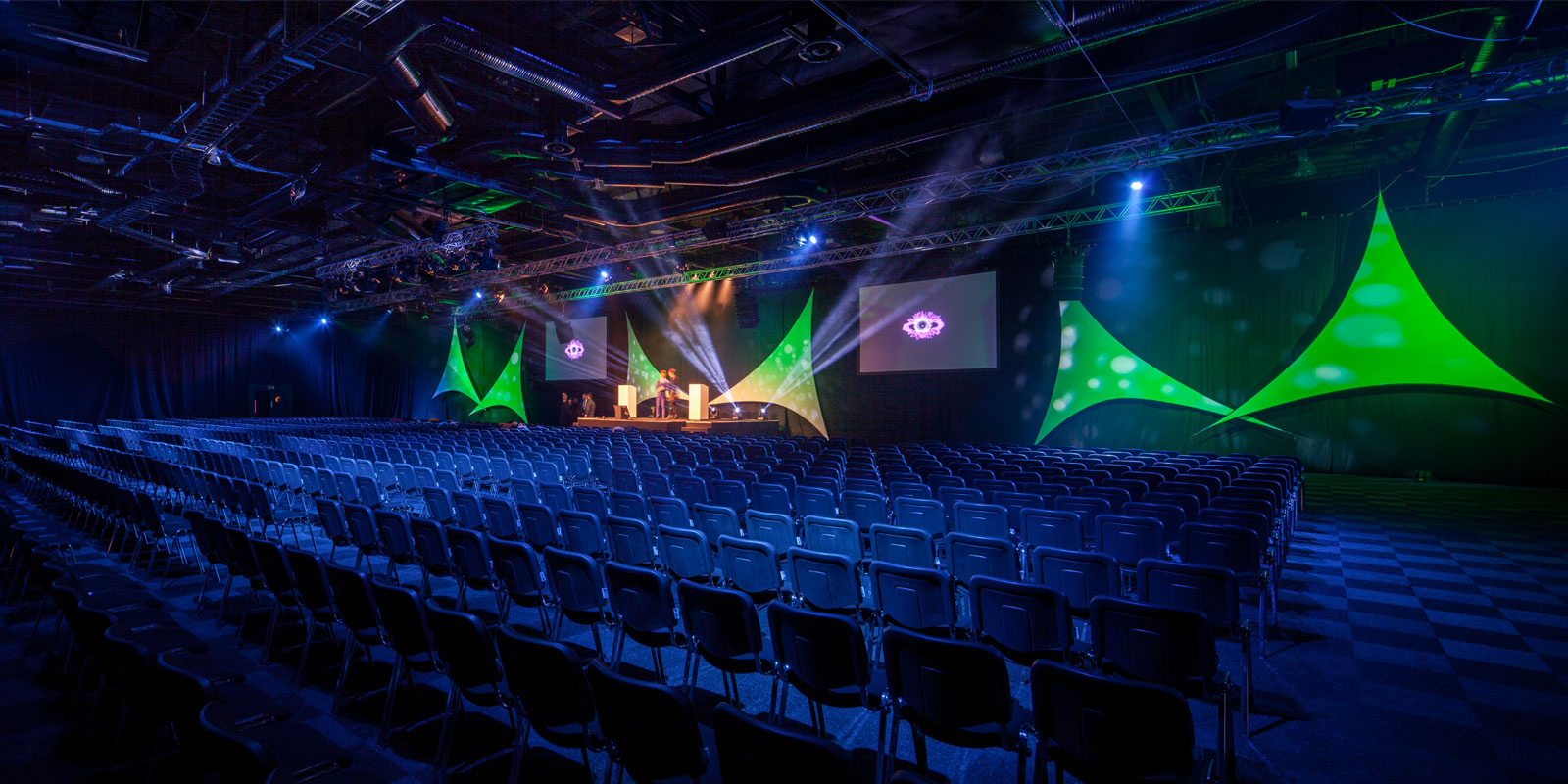 Auditorium-style conference hall with dynamic lighting for large-scale events