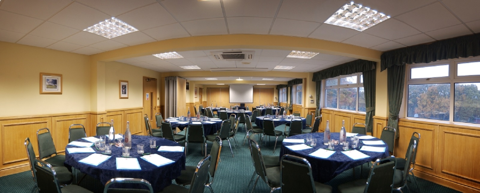 Syndicate Rooms at Haydock Park, set for a professional event with round tables.