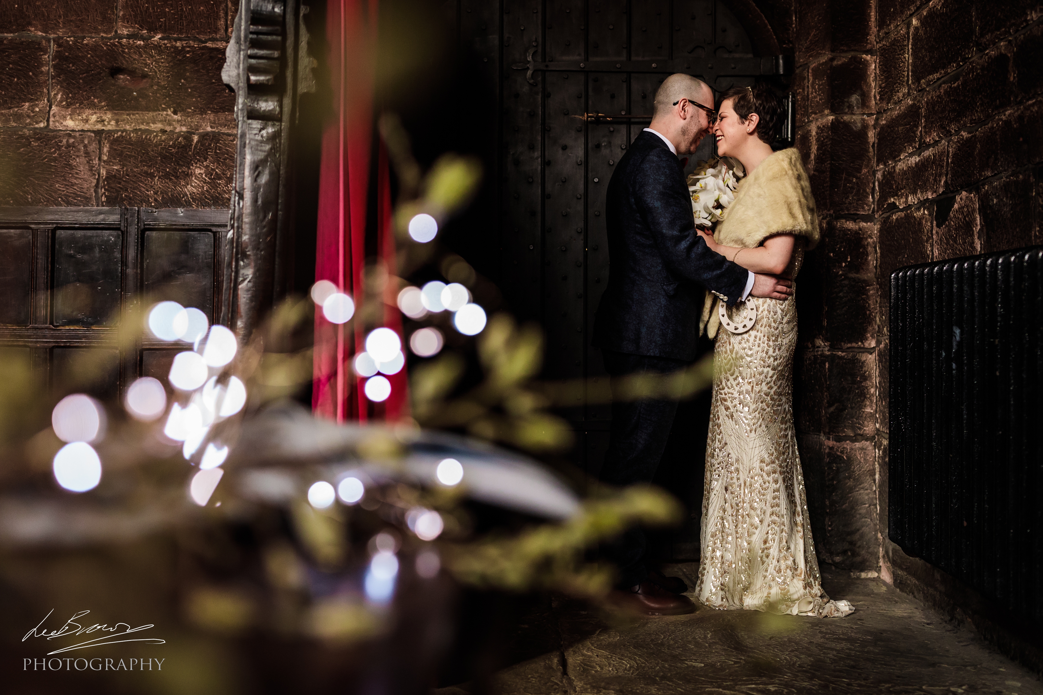 Couple in elegant attire at Baronial Hall, Chetham's Library, perfect for weddings.