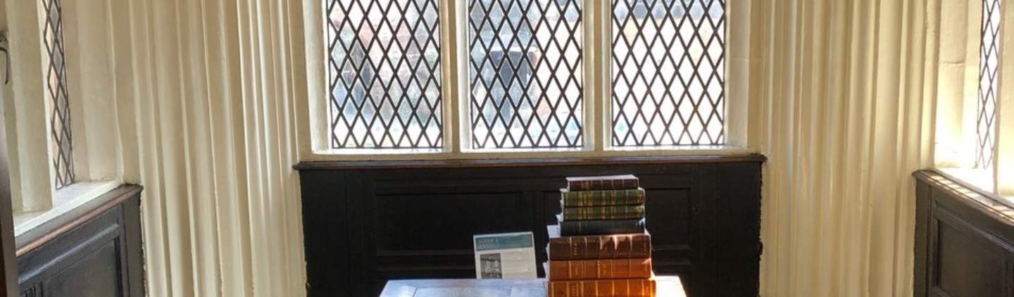 Chetham's Library Association Room with wooden table, ideal for meetings and gatherings.