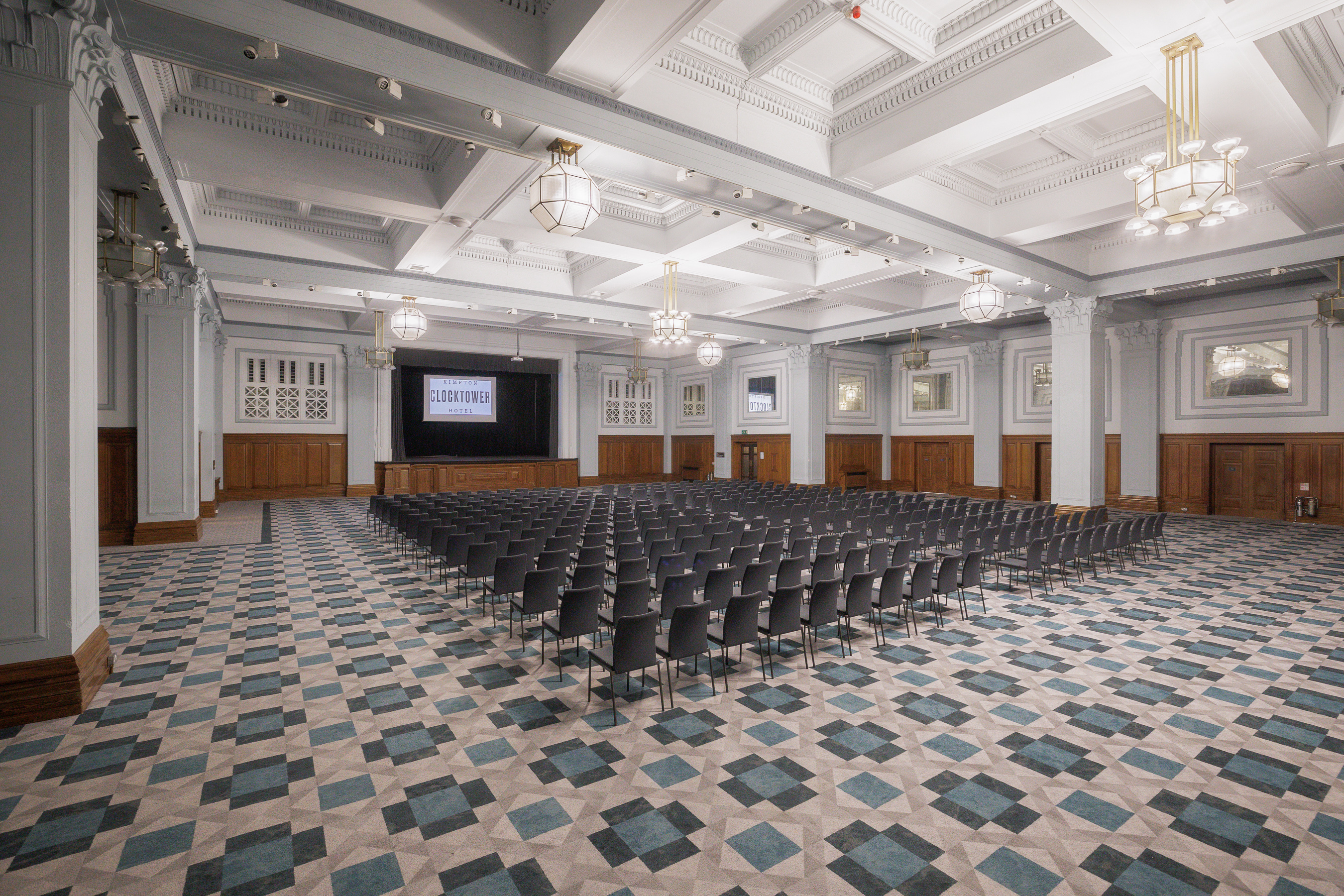 Spacious ballroom at Kimpton Clocktower Hotel, ideal for conferences and presentations.