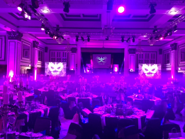 Ballroom at Kimpton Clocktower Hotel, elegant gala setup with purple lighting and fog.