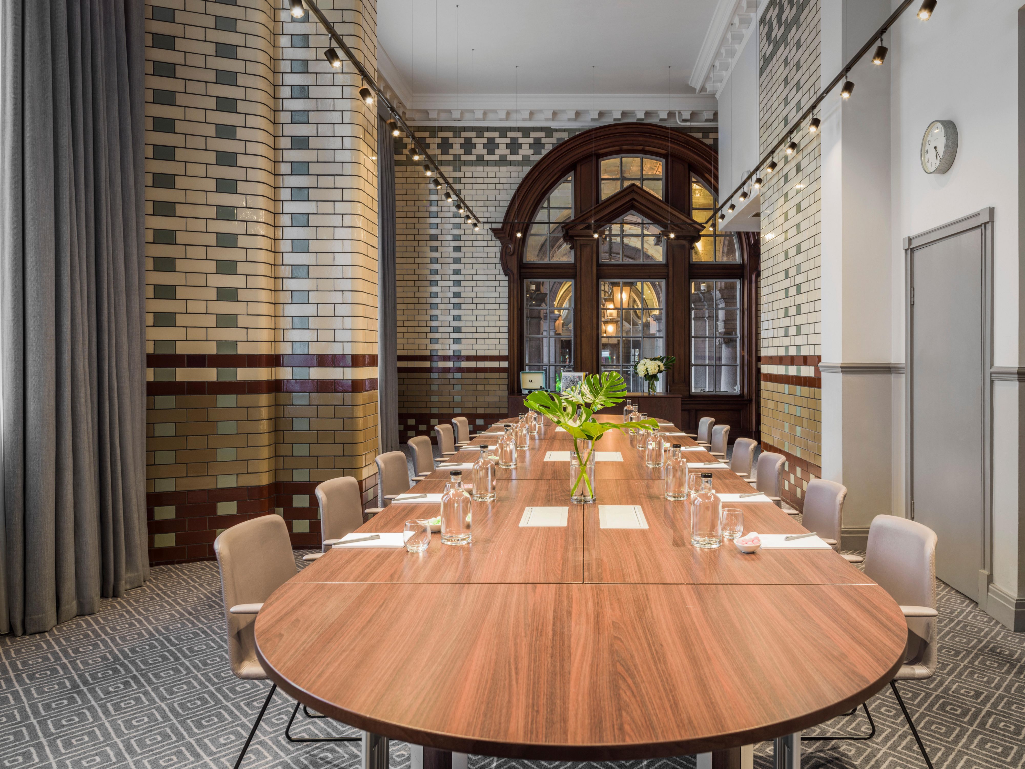 Sophisticated meeting room at Kimpton Clocktower Hotel with elegant oval table.