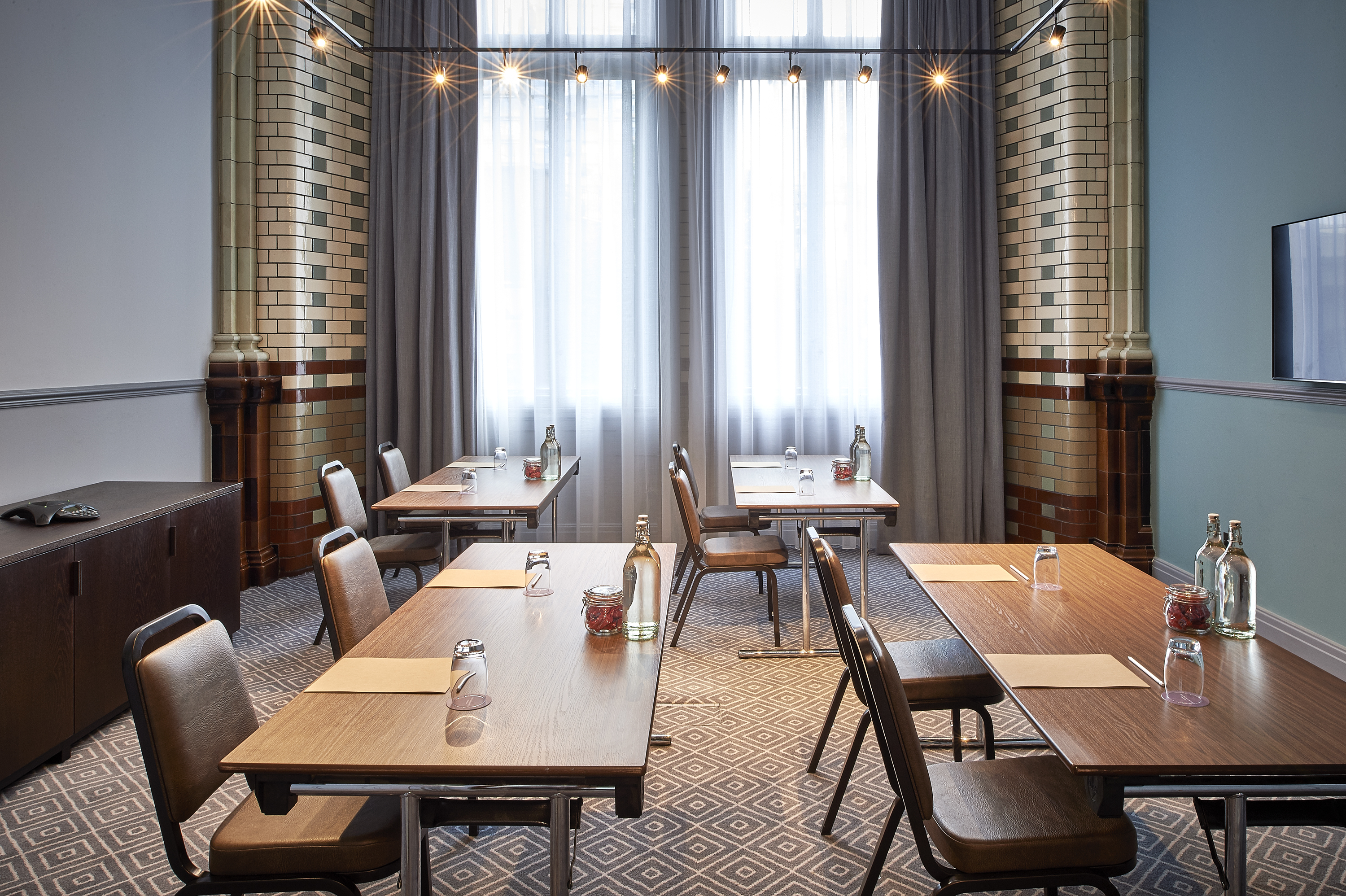 Well-lit meeting room at Kimpton Clocktower Hotel, perfect for workshops and gatherings.