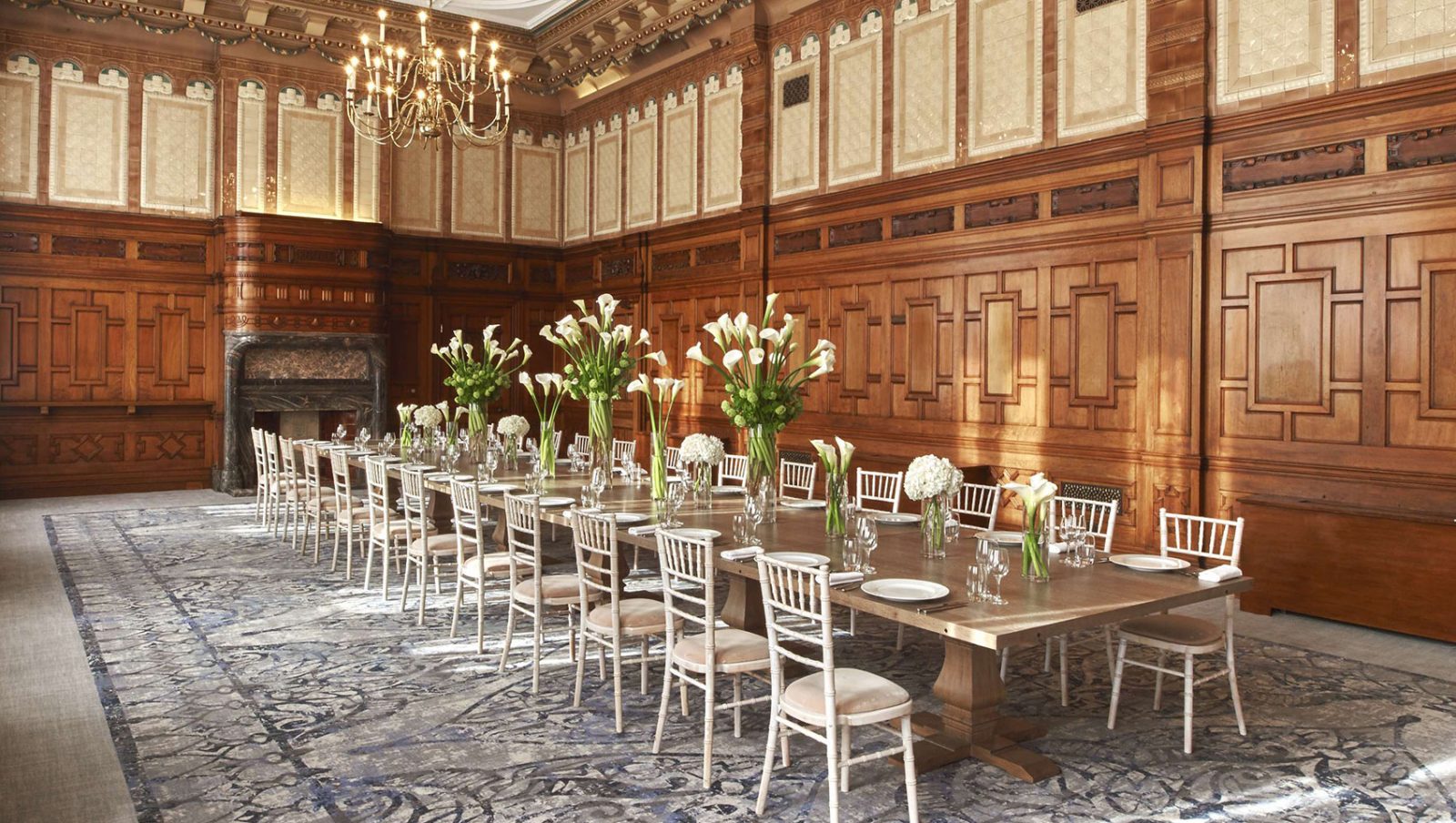 Winter Garden boardroom with elegant floral centerpieces for executive dinner or corporate event.