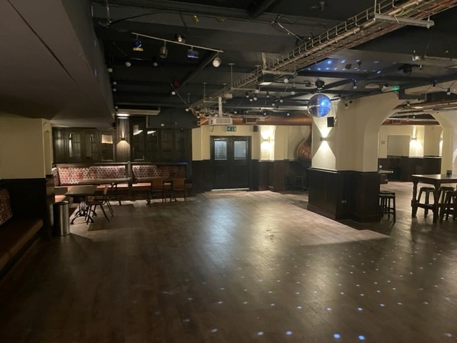 Versatile event space at Kimpton Clocktower Hotel with polished flooring for gatherings.