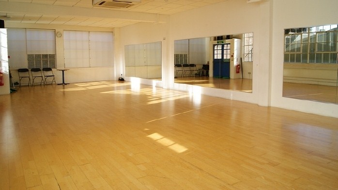 Spacious STUDIO 3 with polished floors, ideal for workshops and fitness classes.