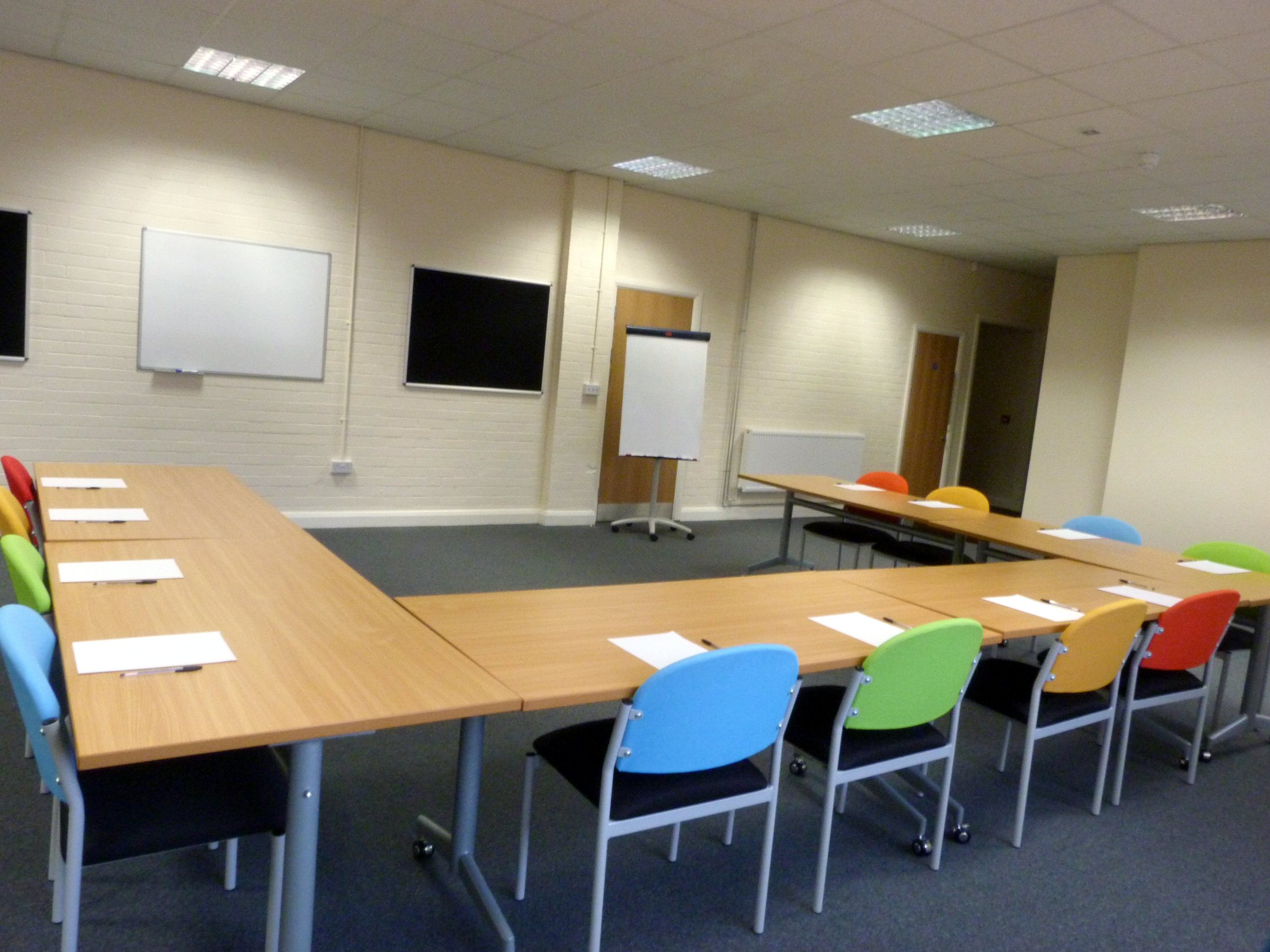 Training Room 1 at Redbank House: flexible table, colorful chairs for meetings and workshops.