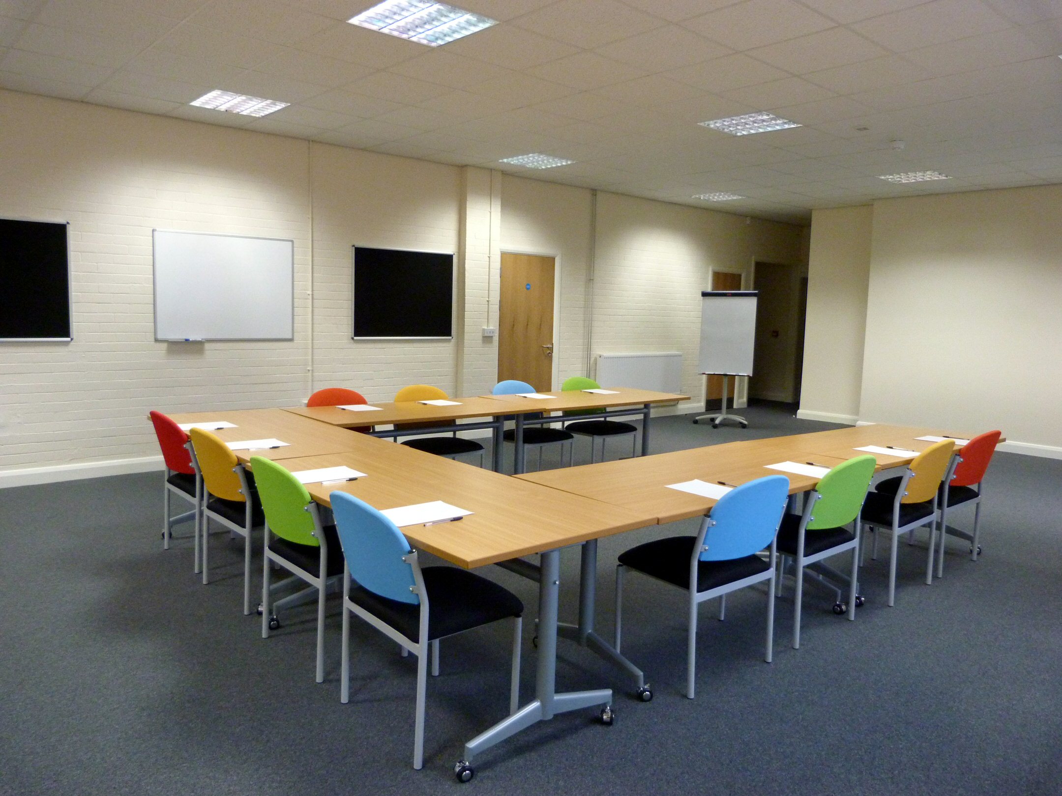 Training Room 1 at Redbank House with U-shaped table for collaborative meetings.