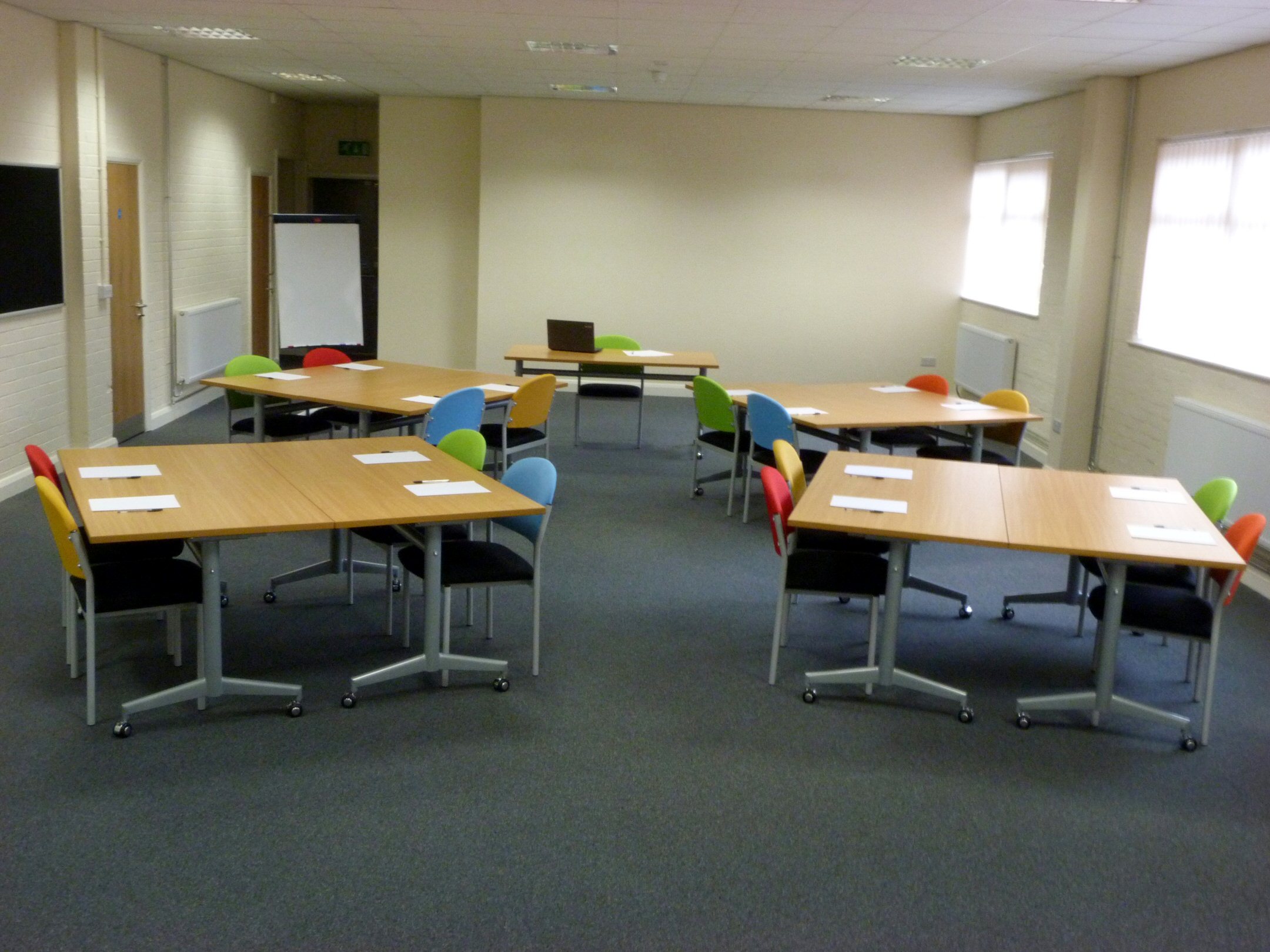 Training Room 1 at Redbank House, U-shaped tables, ideal for workshops and brainstorming.