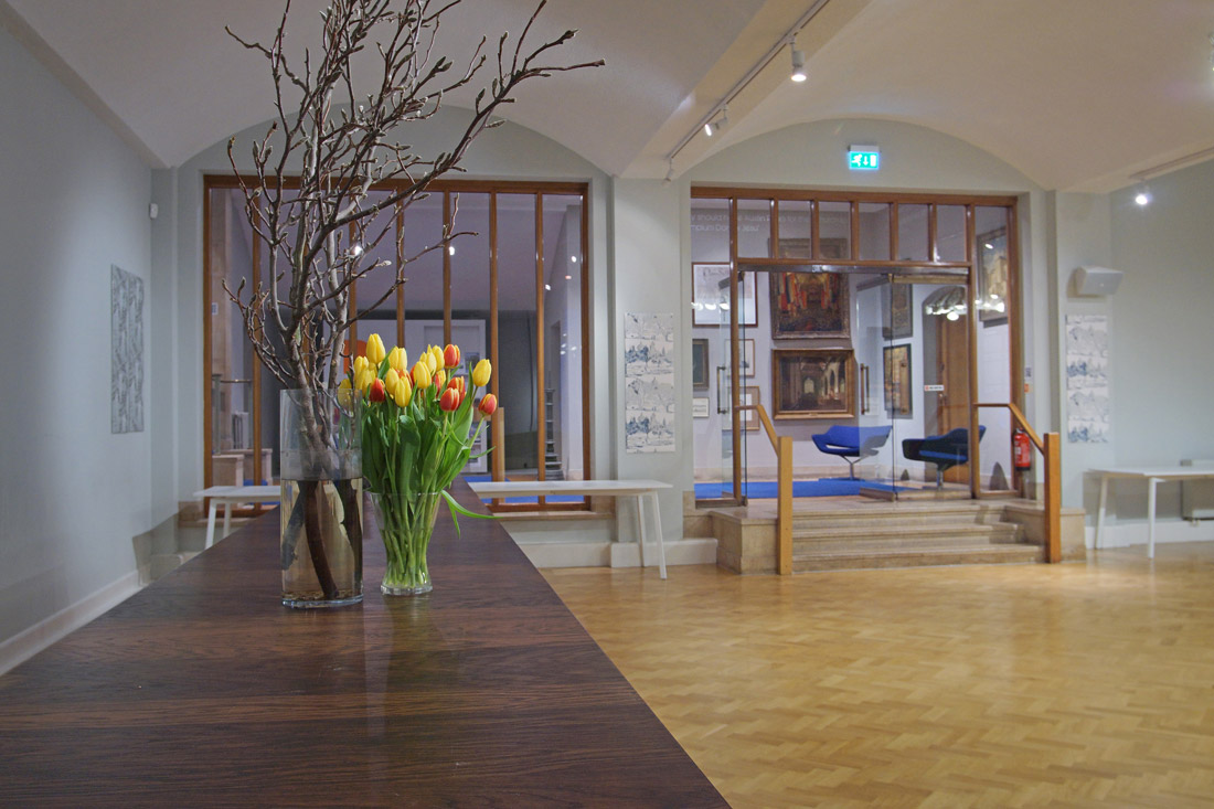Modern event space in The Dutch Hall with polished wooden table, ideal for networking events.
