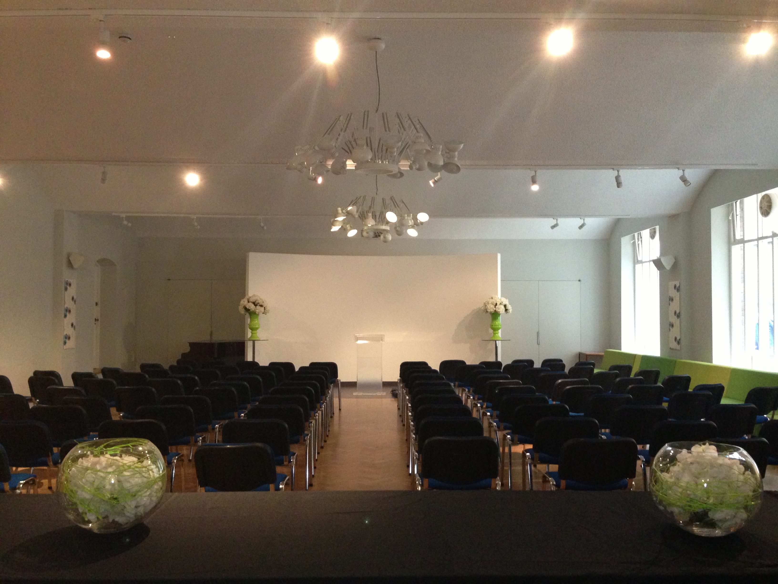 Whole Venue in The Dutch Hall with black chairs, ideal for meetings and presentations.