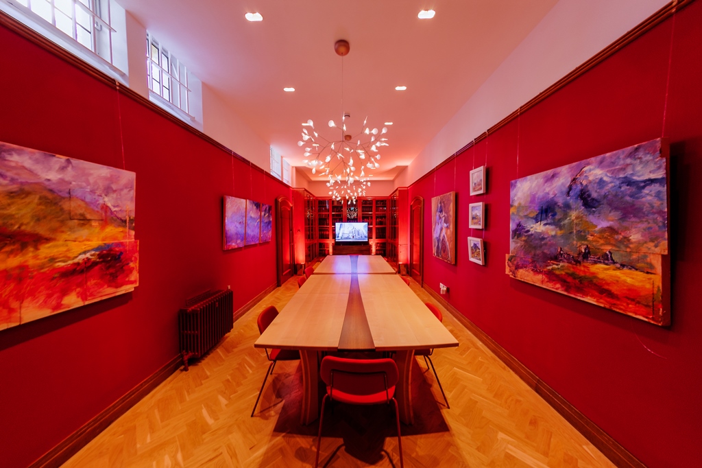Vibrant meeting space in The Dutch Hall with wooden table, ideal for gatherings and brainstorming.