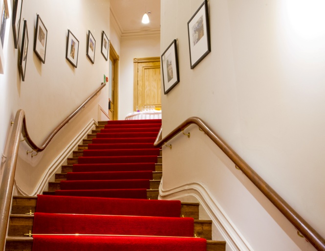 Thomas Worthington Room staircase with red carpet, ideal for upscale events and meetings.