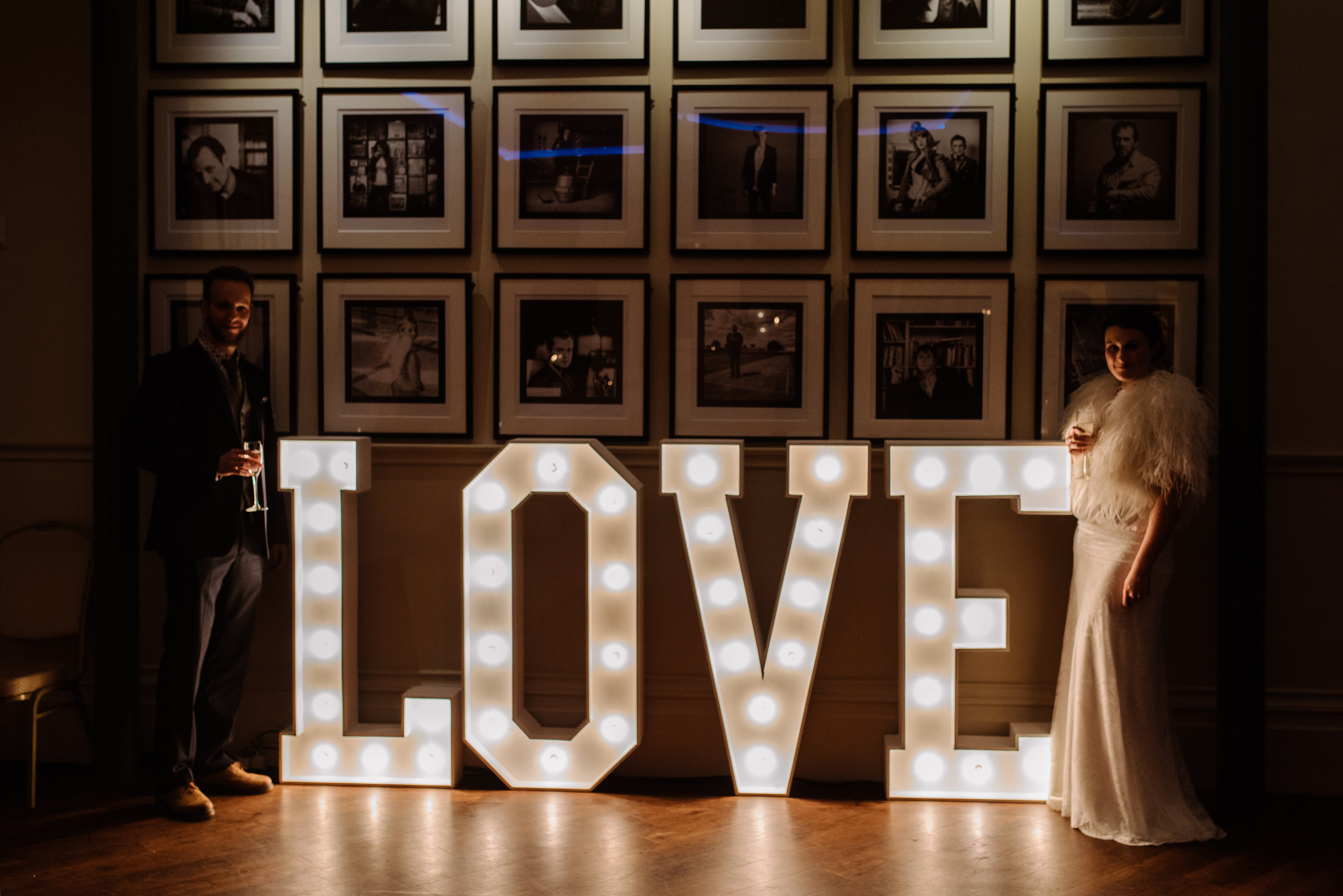 Elegant wedding backdrop with illuminated "LOVE" sign at Fountain House.