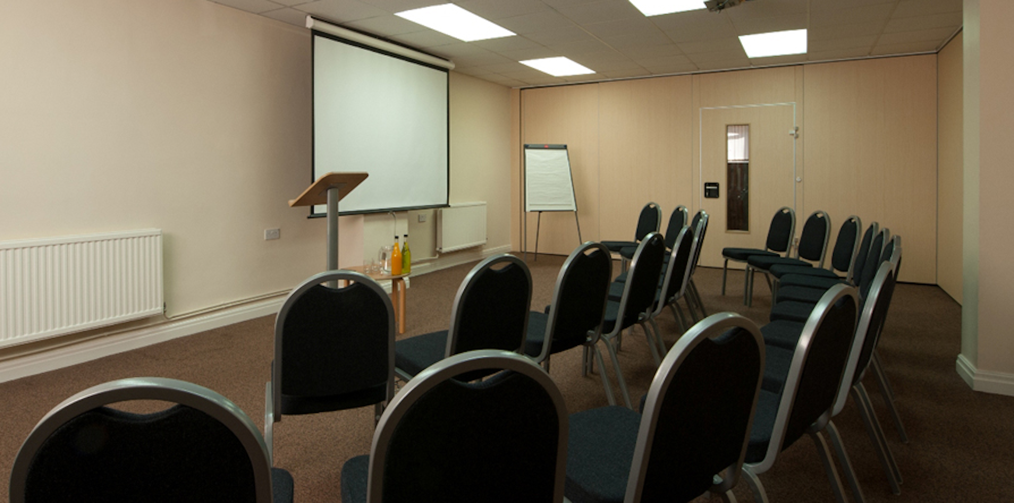 Seminar Room 4 at King's House: functional meeting space for workshops and presentations.